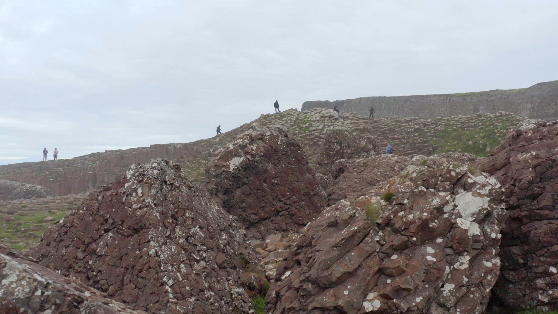 Tourists Exploring Giant's Causeway in Northern Ireland