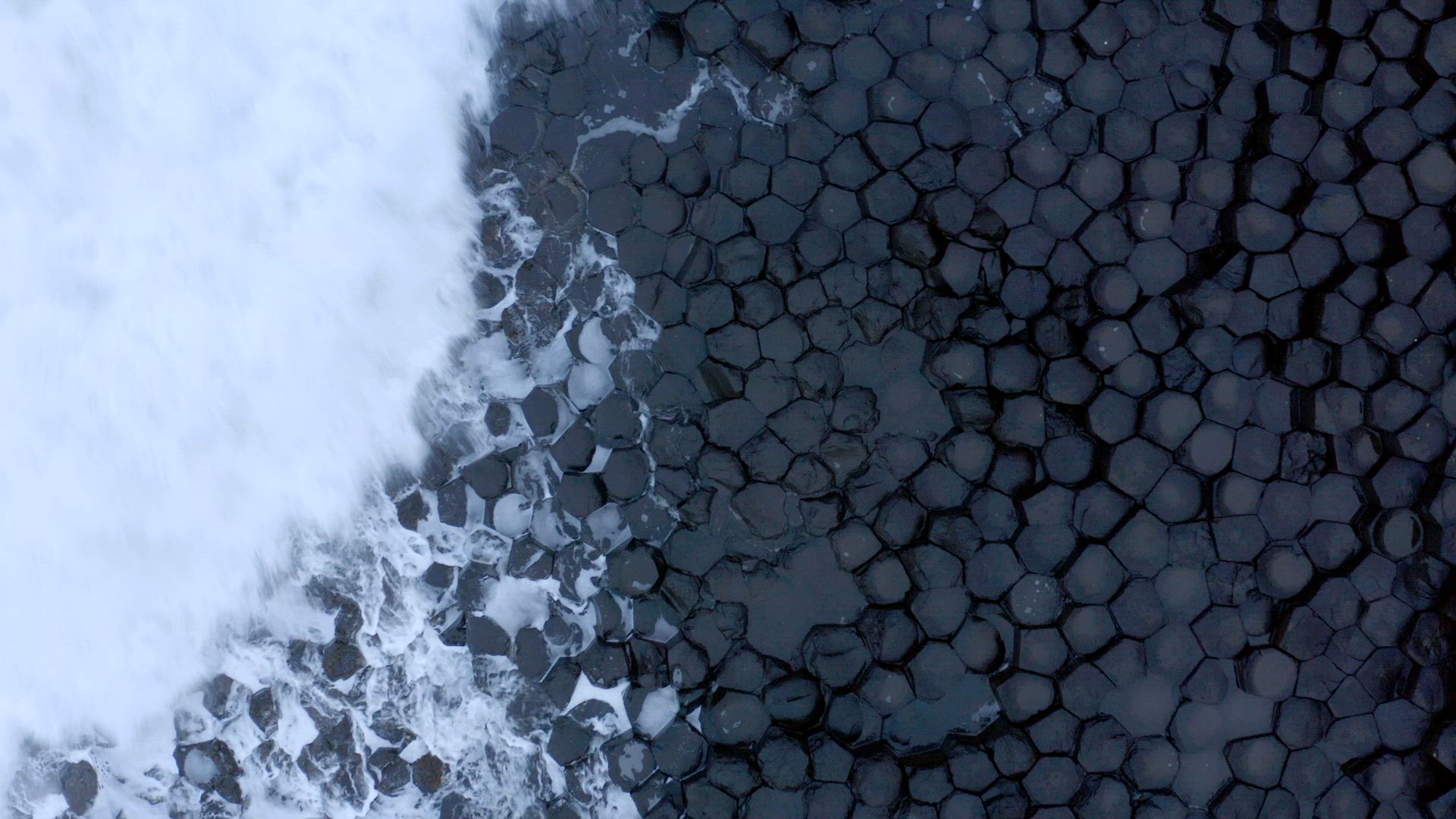 Ocean Waves Crashing Against Hexagonal Basalt Rock Formation at Giant's Causeway