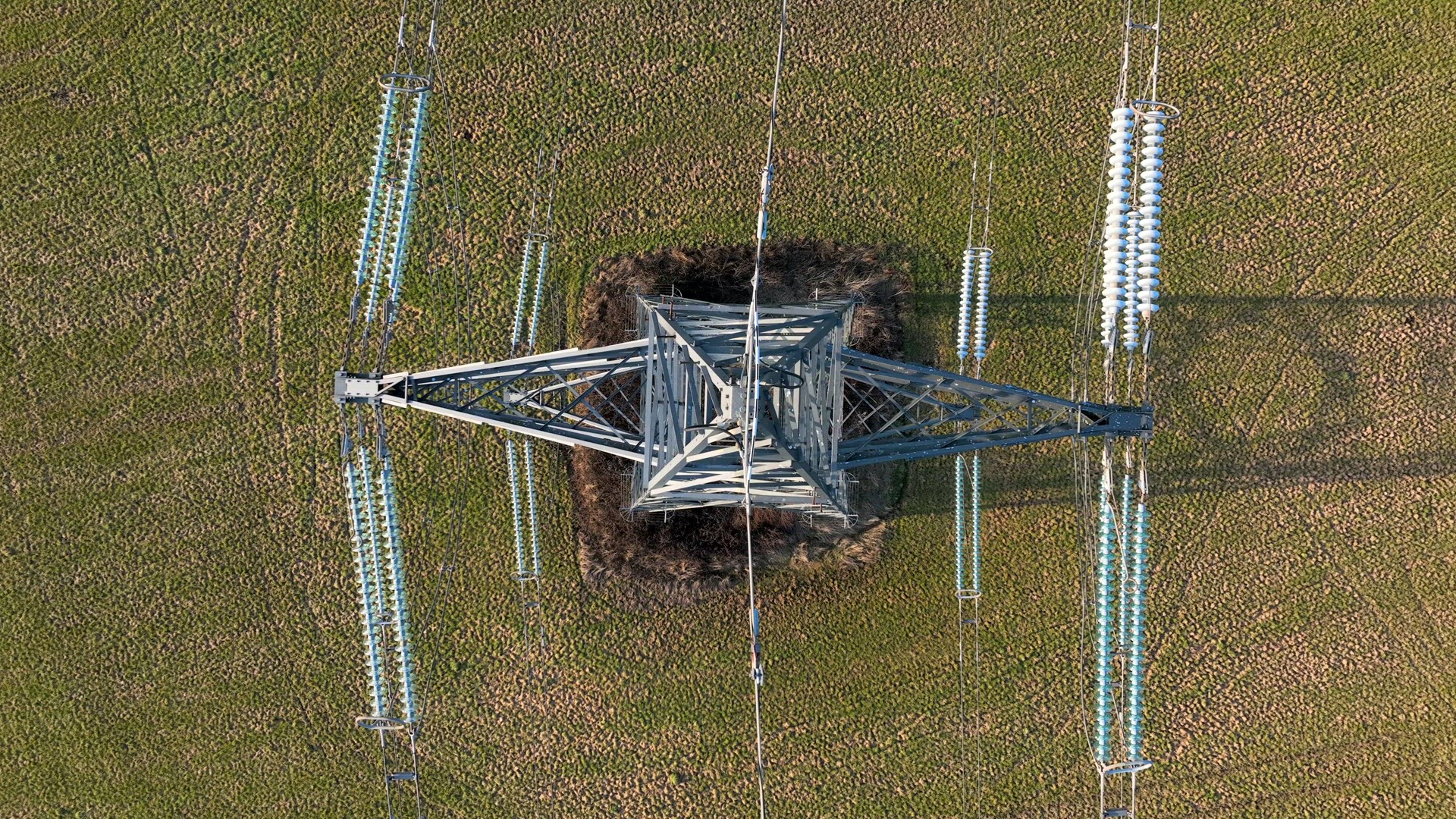 Bird's Eye View of Industrial High Voltage Lattice Power Line Tower