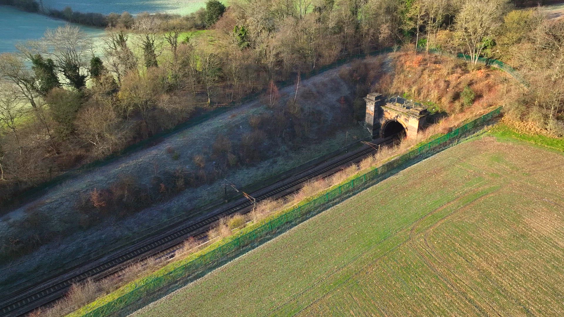 Train Carrying Commuters Speeding Through the Countryside Aerial View