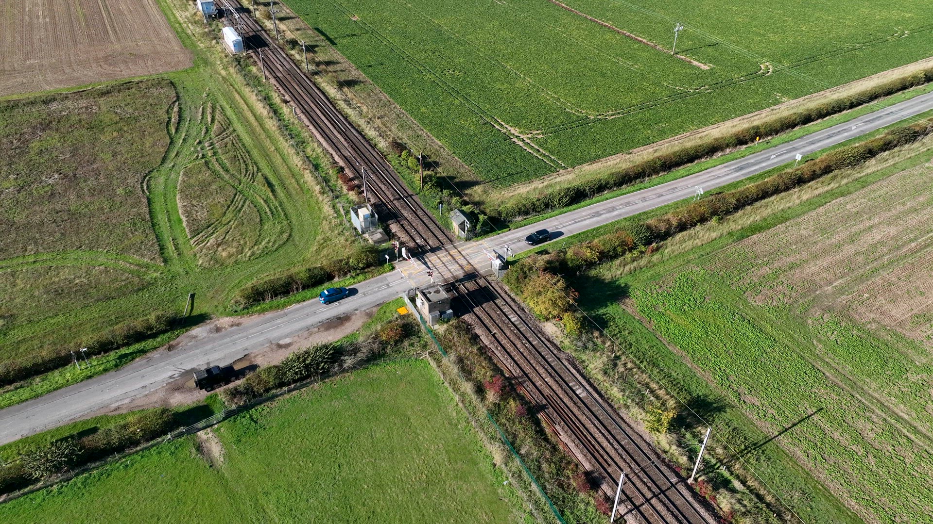 Fast Commuter Train Passing Over a Level Crossing