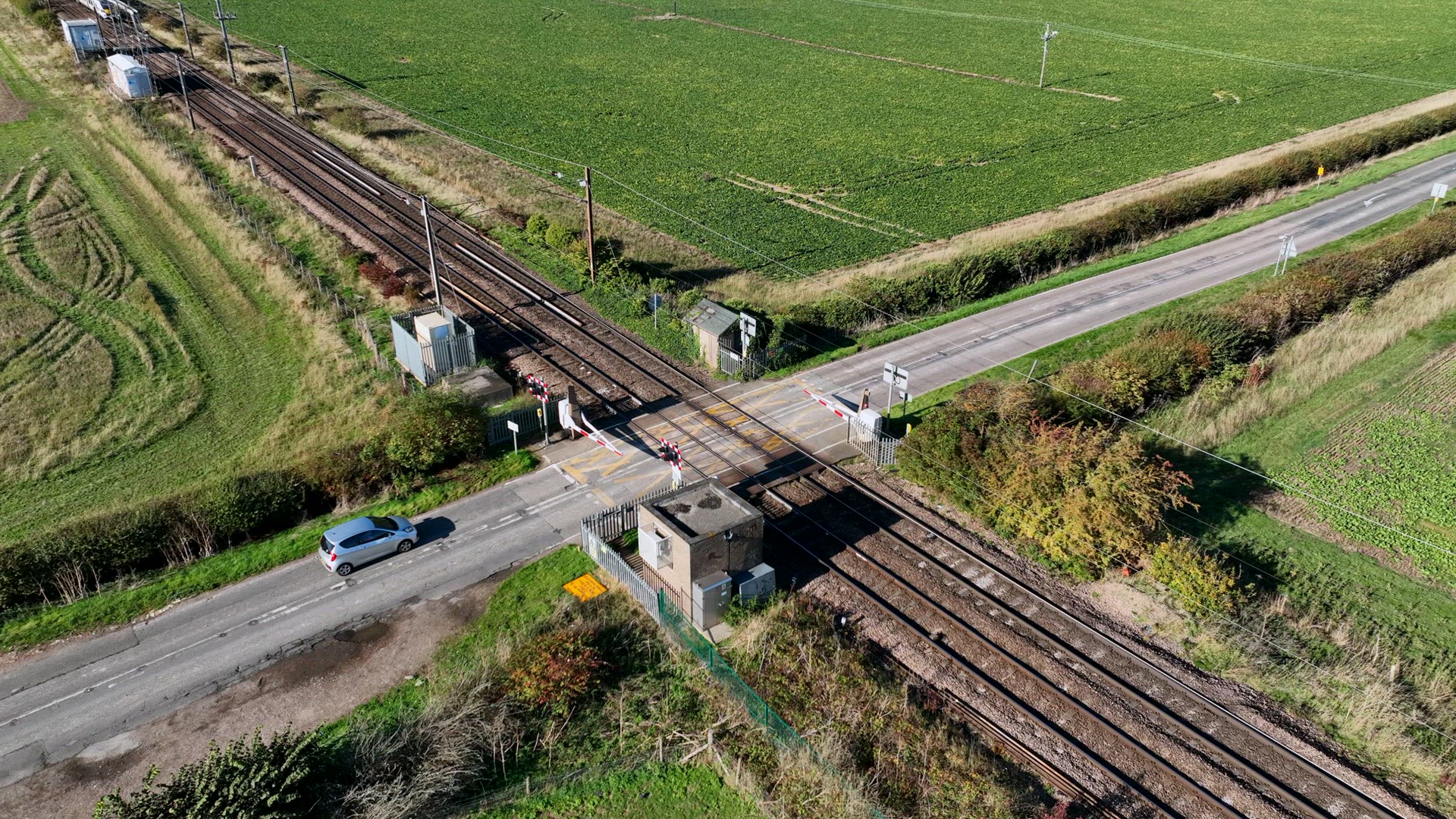 Fast Commuter Train Passing Over a Level Crossing