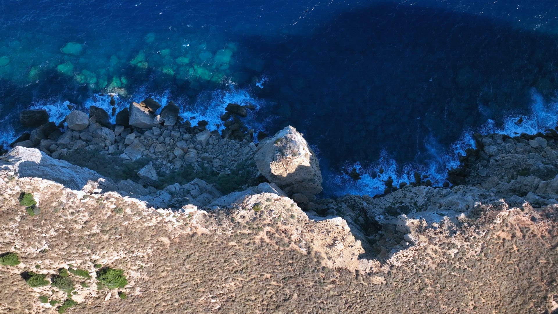 Waves Crashing Against Rocks on the Steep Shores of an Island