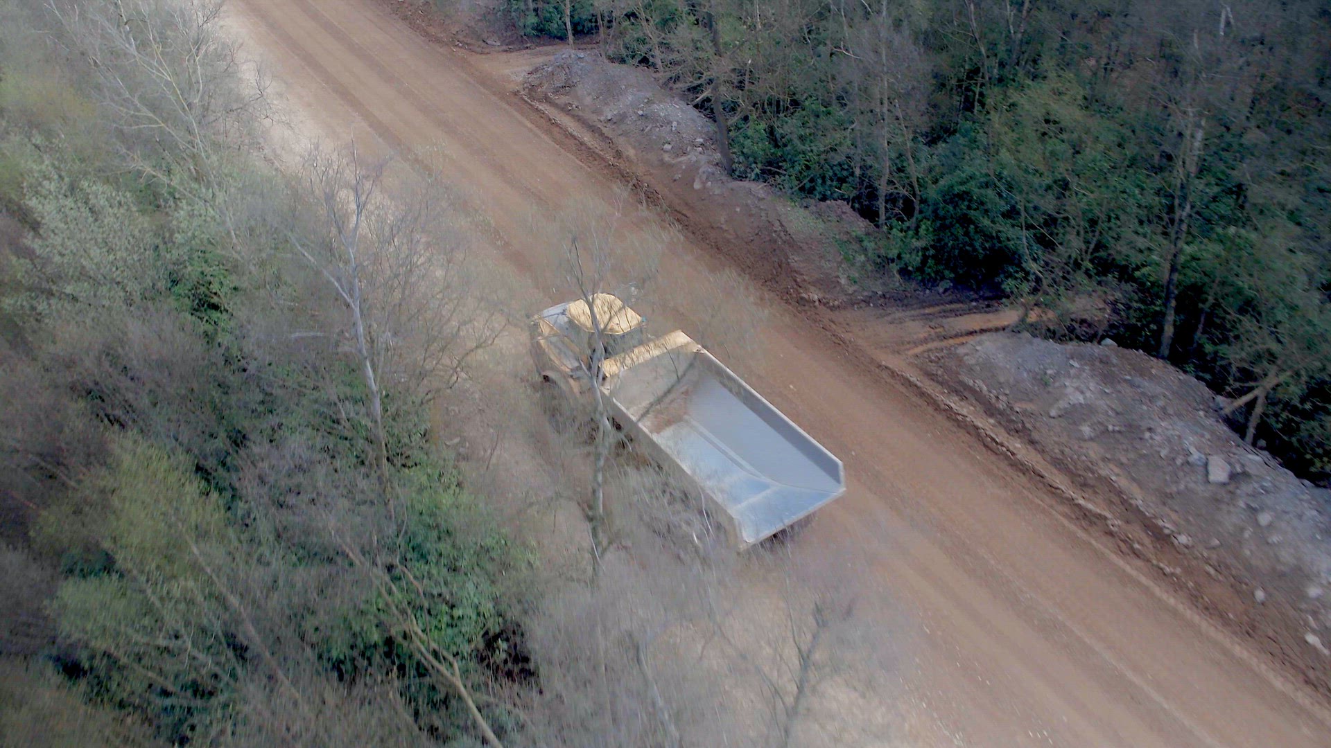 Large Vehicles Working Around a Large Open Quarry