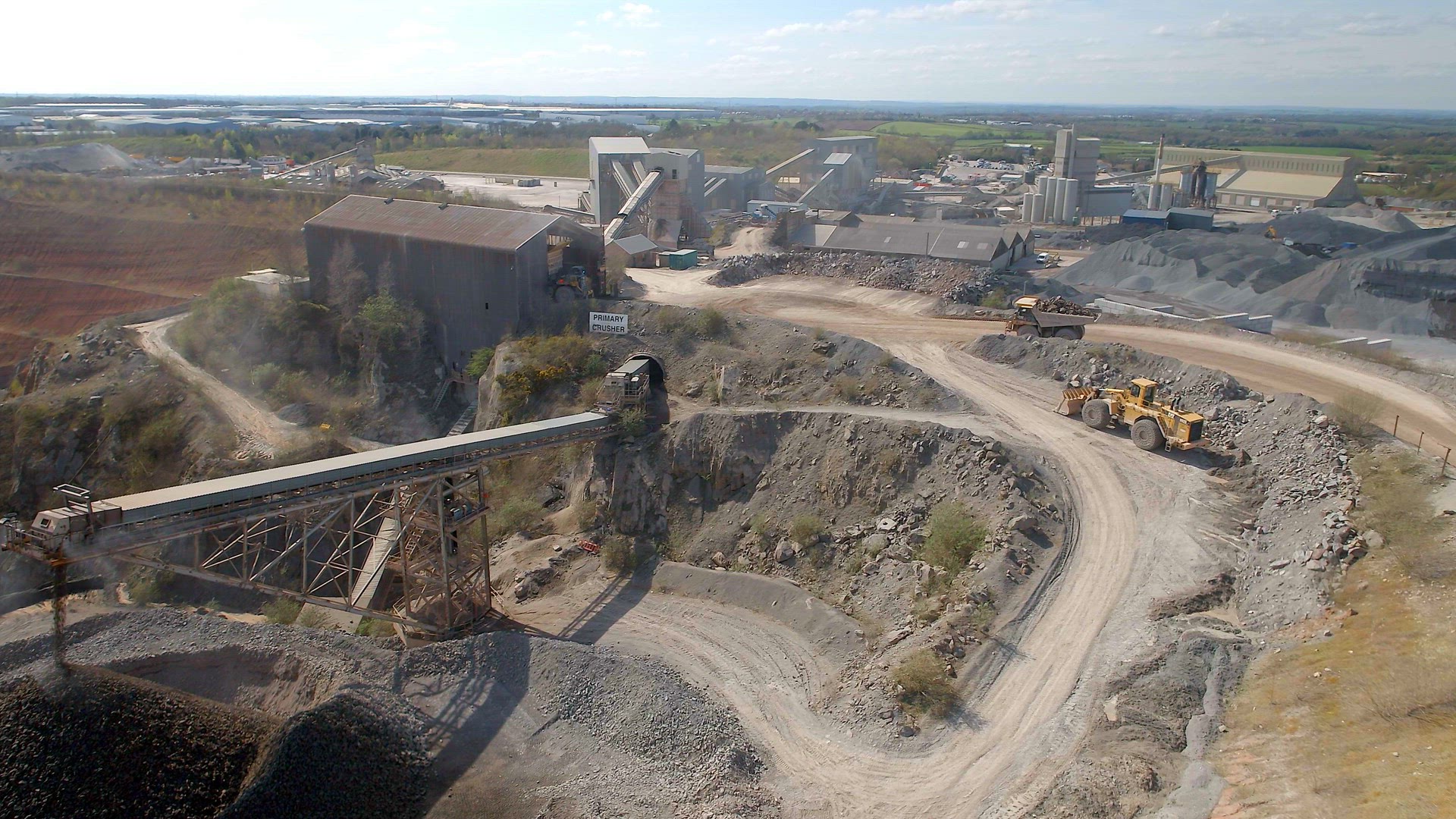 A Huge Dump Truck Taking Ore to a Refinery in a Quarry