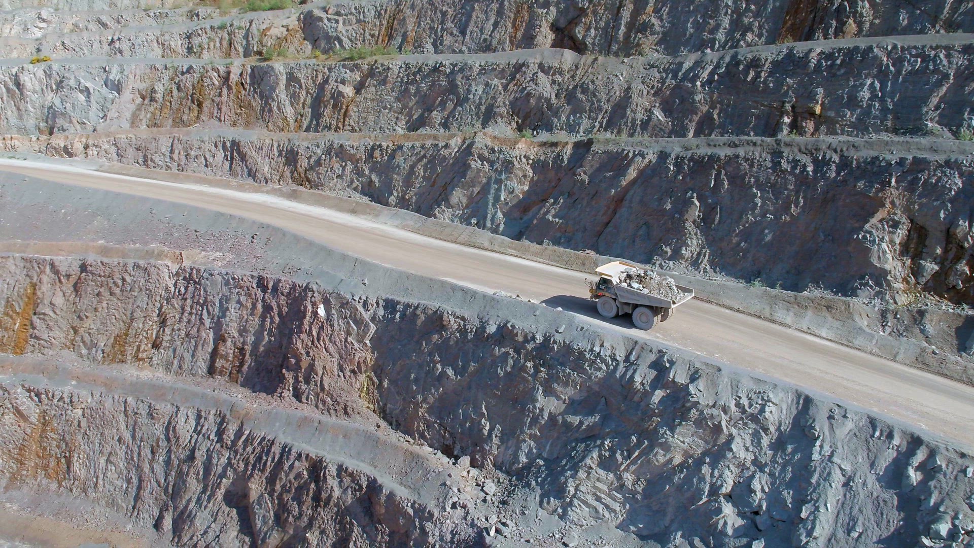Large Vehicles Working Around a Large Open Quarry