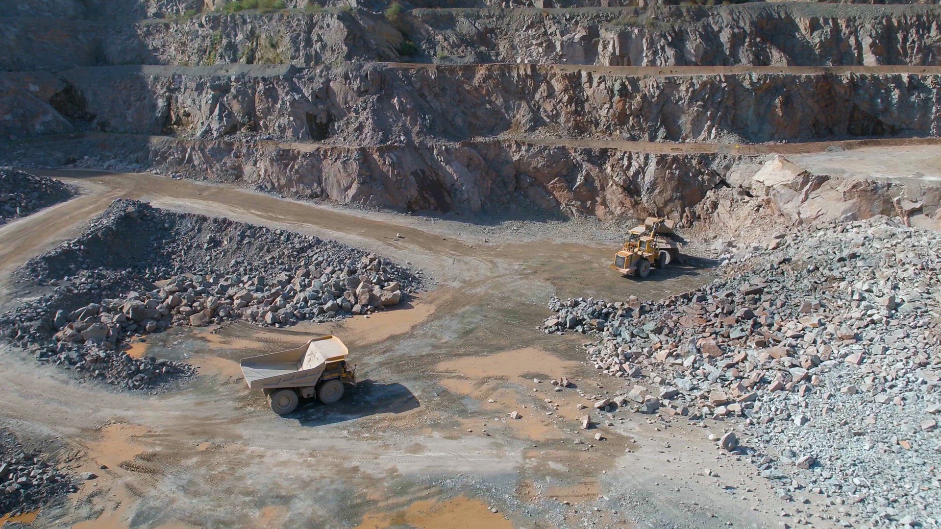 Large Vehicles Working Around a Large Open Quarry