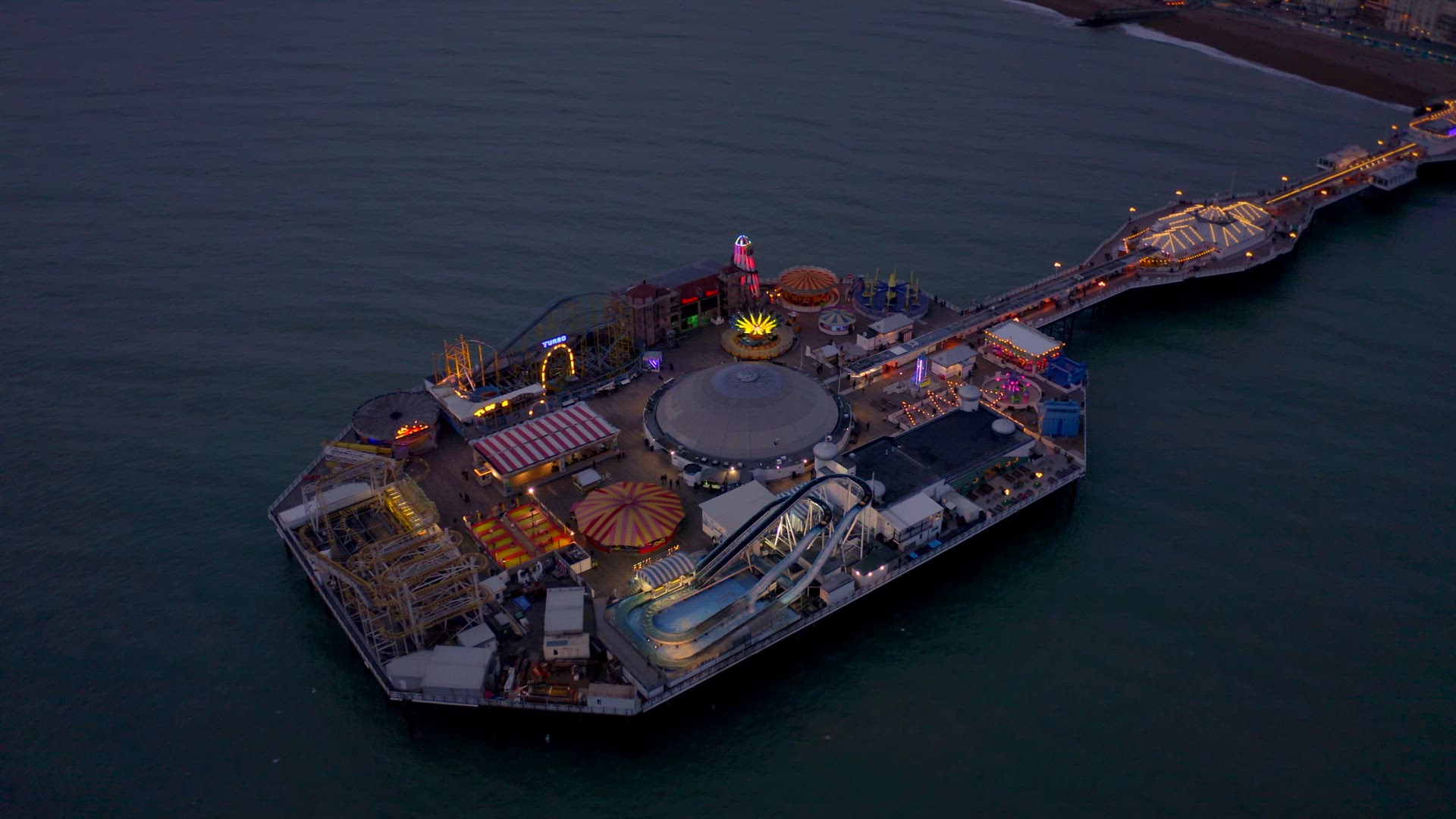 Brighton Seafront Pier Illuminated at Night Aerial View