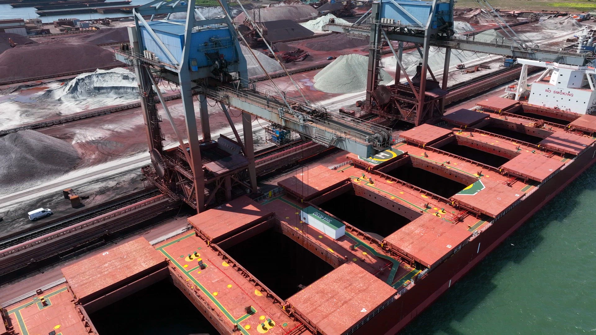 Bulk Carrier Ship Offloading Cargo By Crane for Processing