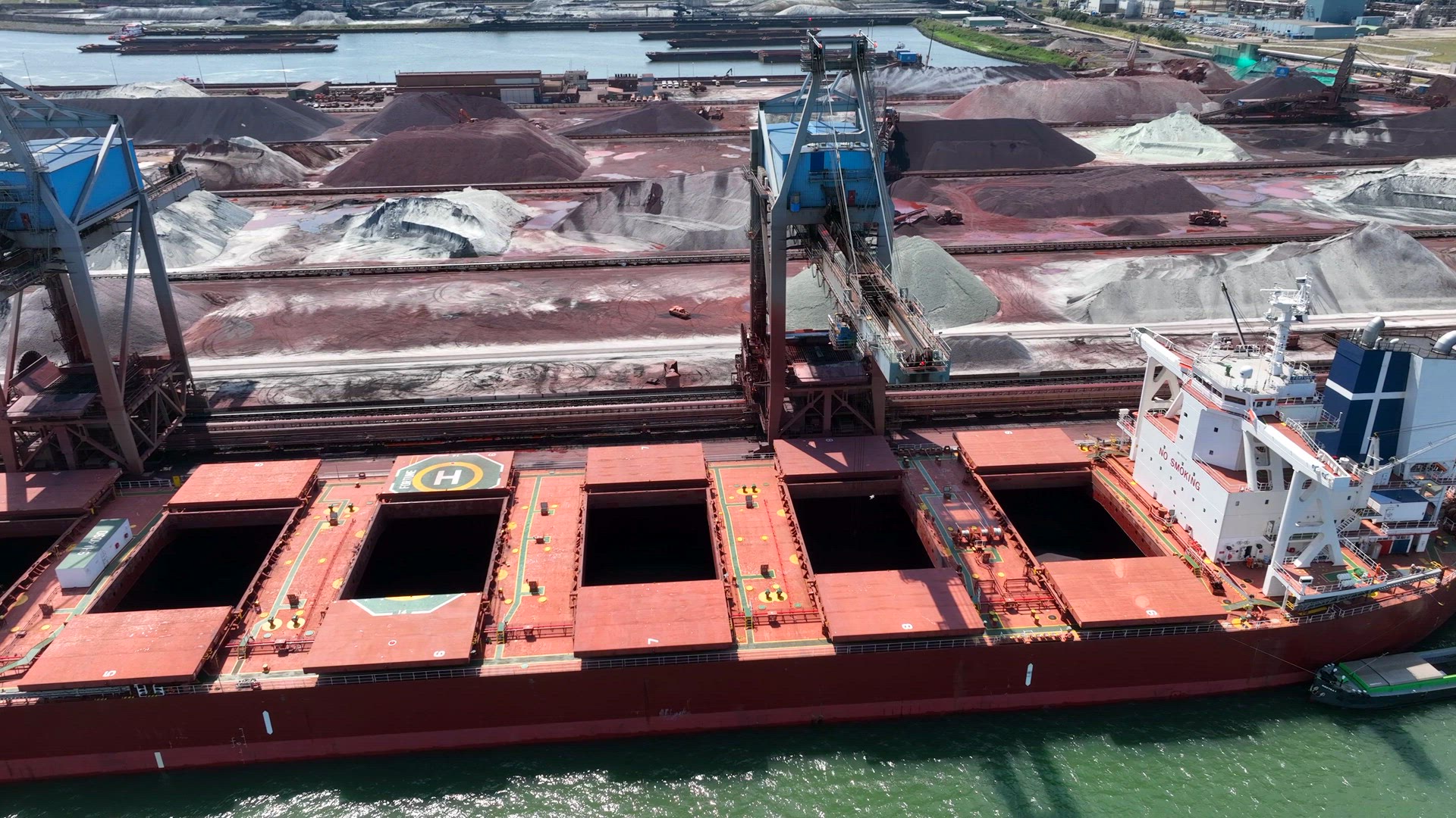Cranes Unloading a Bulk Carrier Ship at Port