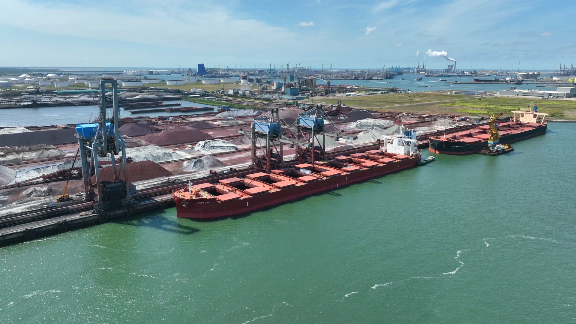 Cranes Unloading a Bulk Carrier Ship at Port