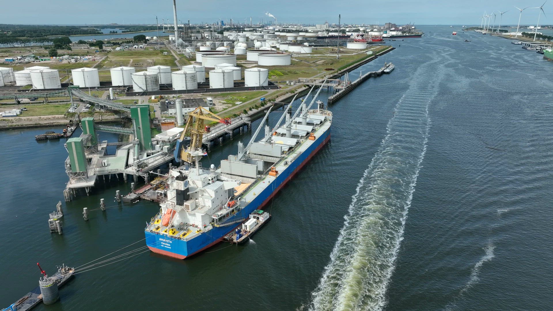 Bulk Carrier Ship at Port Offloading Cargo and Commodities
