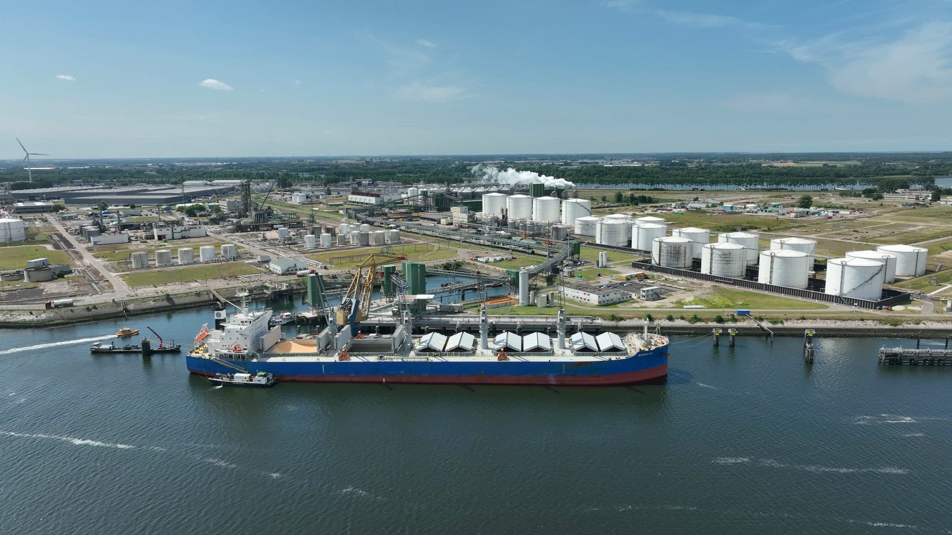 Bulk Carrier Ship at Port Offloading Cargo and Commodities
