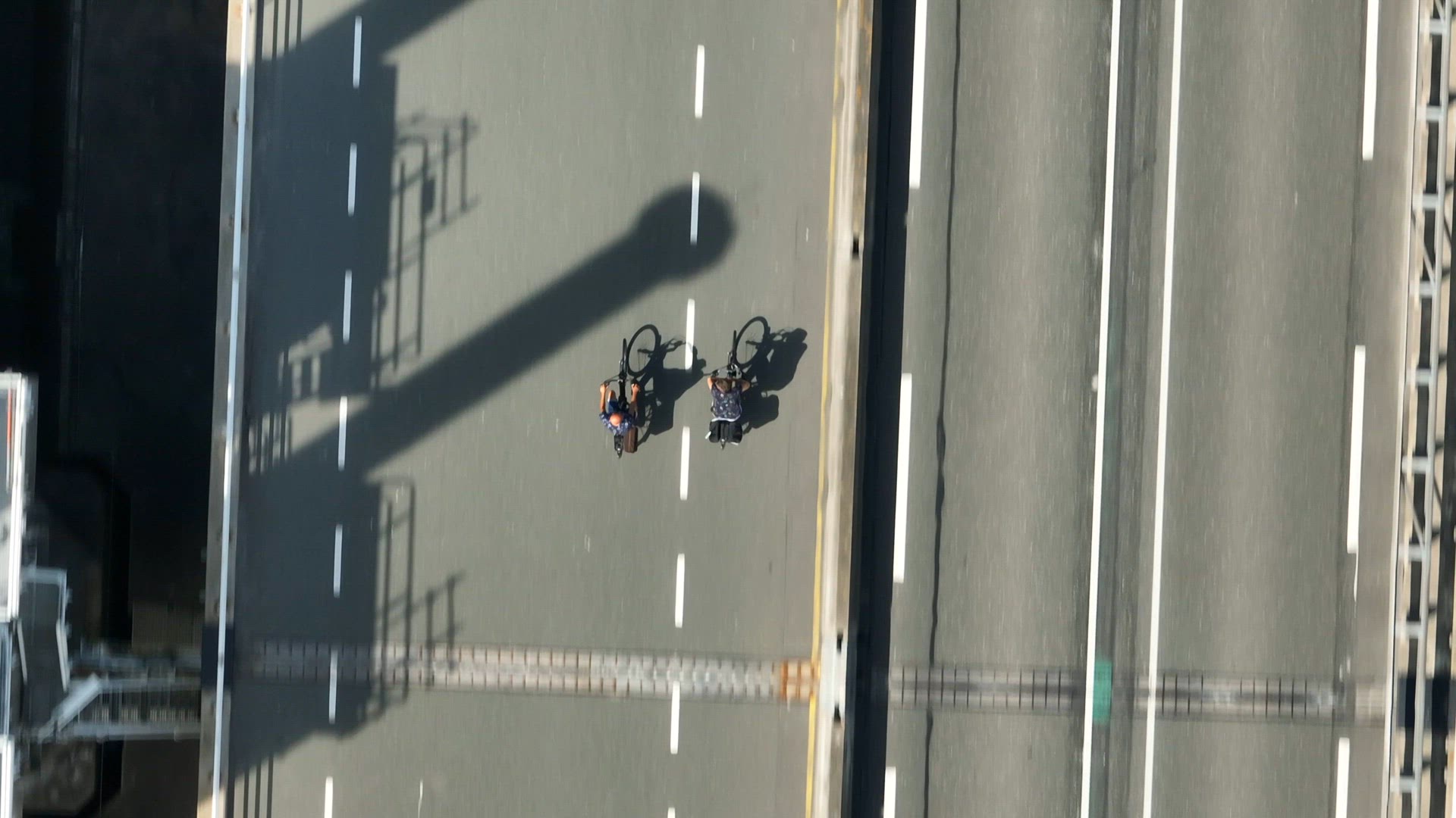 Two Cyclists Riding on a Road Bird's Eye View