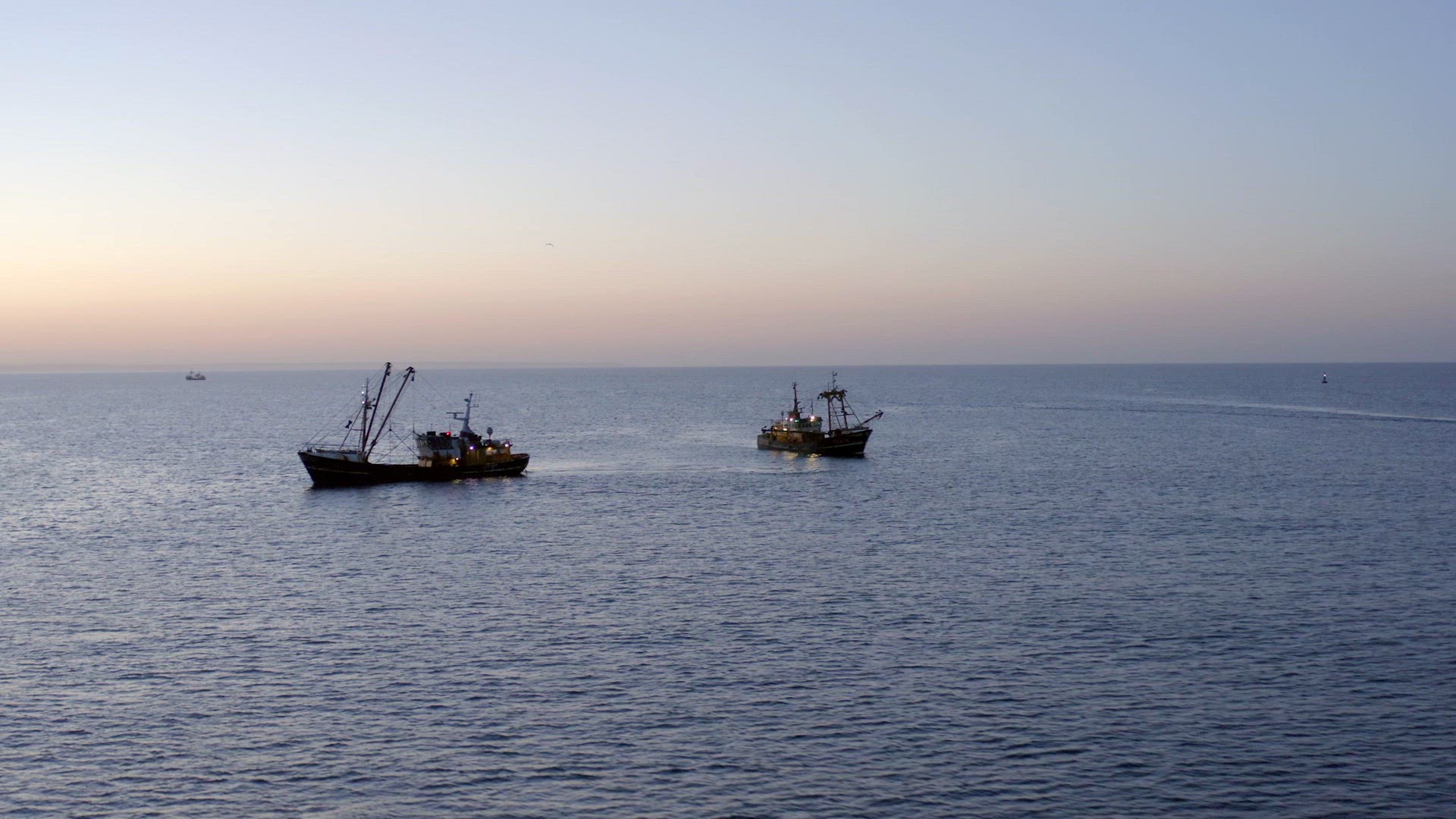 Fishing Trawlers at Sunrise Out at Sea