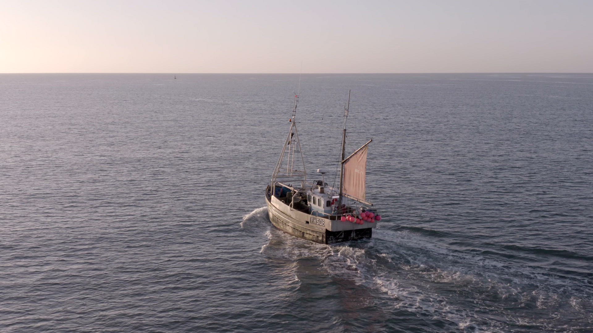 Fishing Boat in the Early Morning Heading Out to Sea