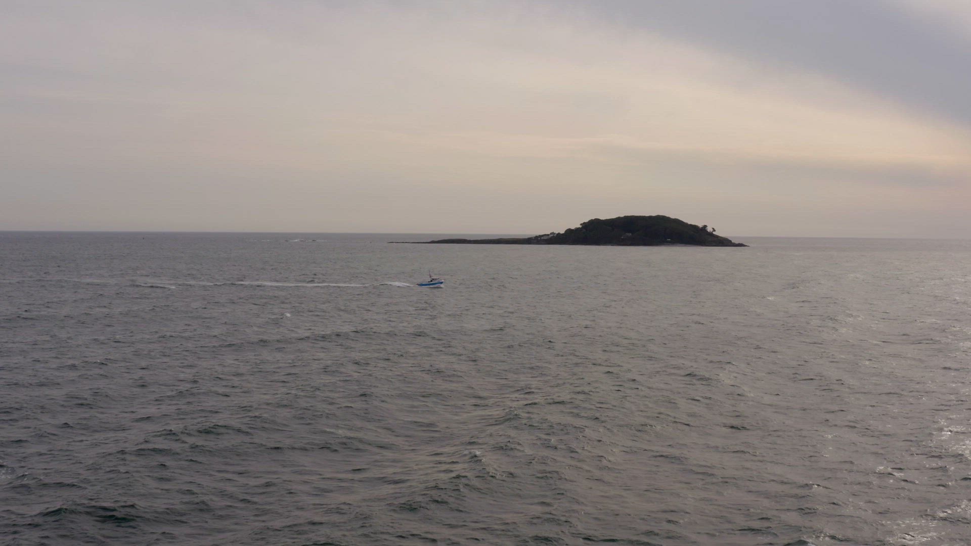 A Fishing Boat Returning To Port At Sunset