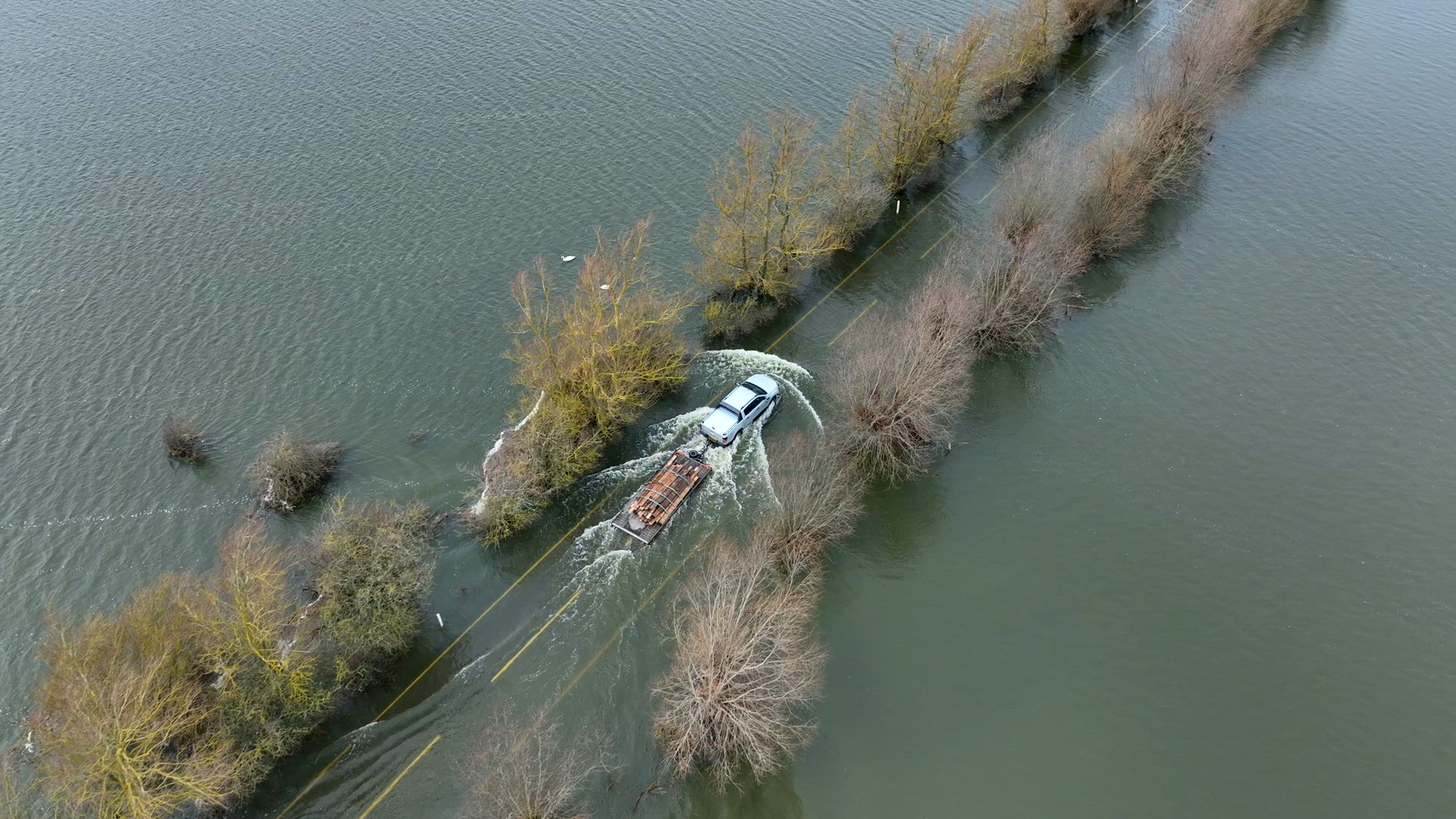 Vehicle Driving Through a Flooded Road Aerial View