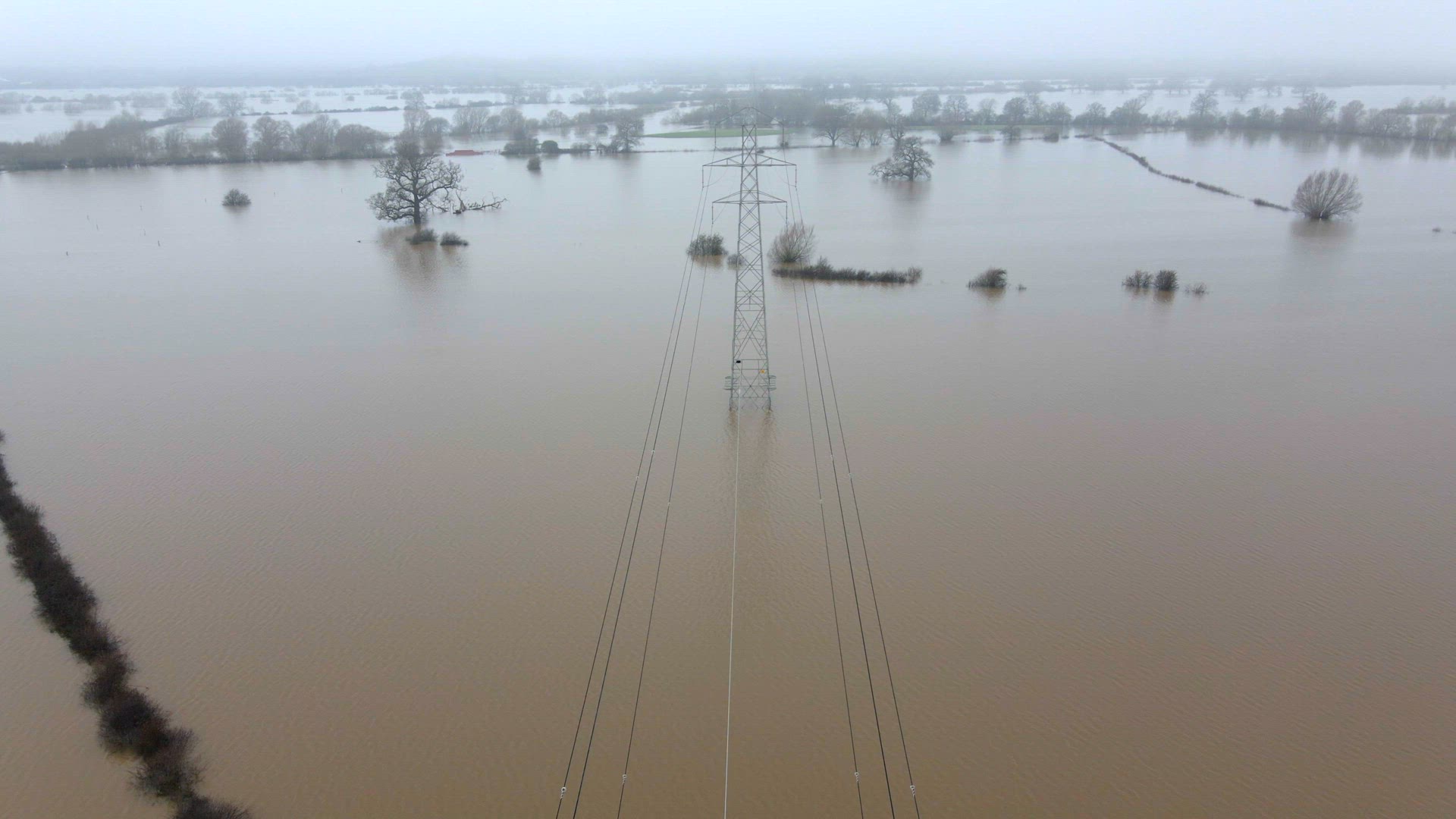 An Electricity Pylon in Deep Water in a Floodwaters Causing Power Outages