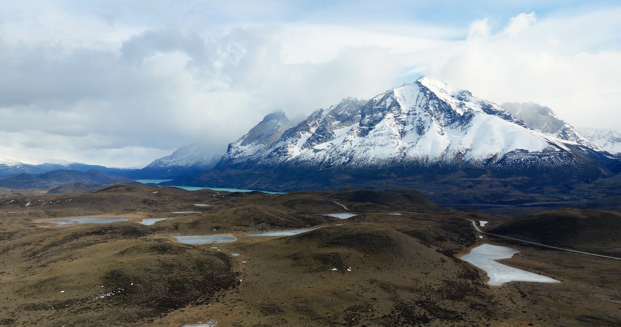 Aerial Dolly Out Revealing Patagonia Landscape with Cuernos del Paine, Chile