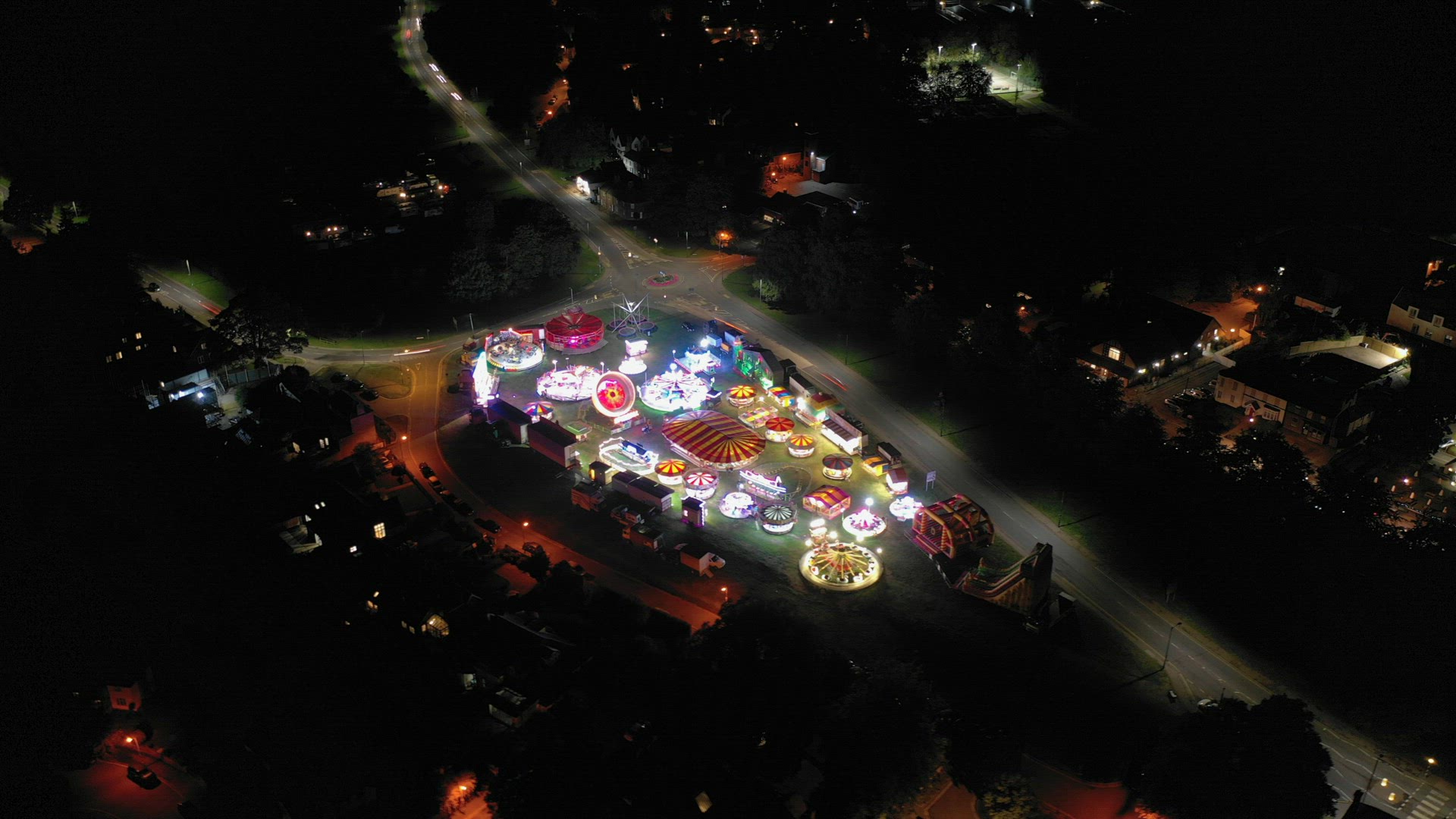 Aerial Hyperlapse of a Travelling Fairground in a Town
