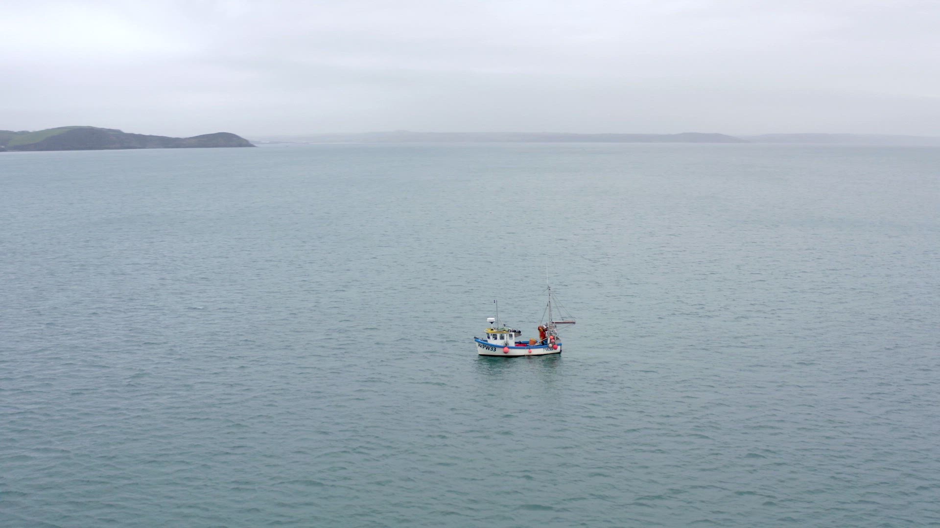 Fishing Boat on a Grey Day Out Catching Fish Aerial View