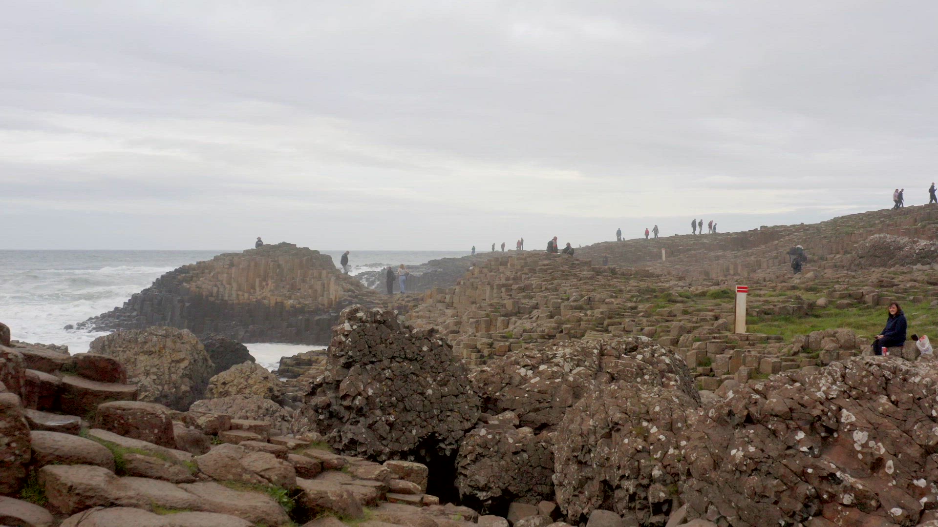 Tourists Exploring Giant's Causeway in Northern Ireland