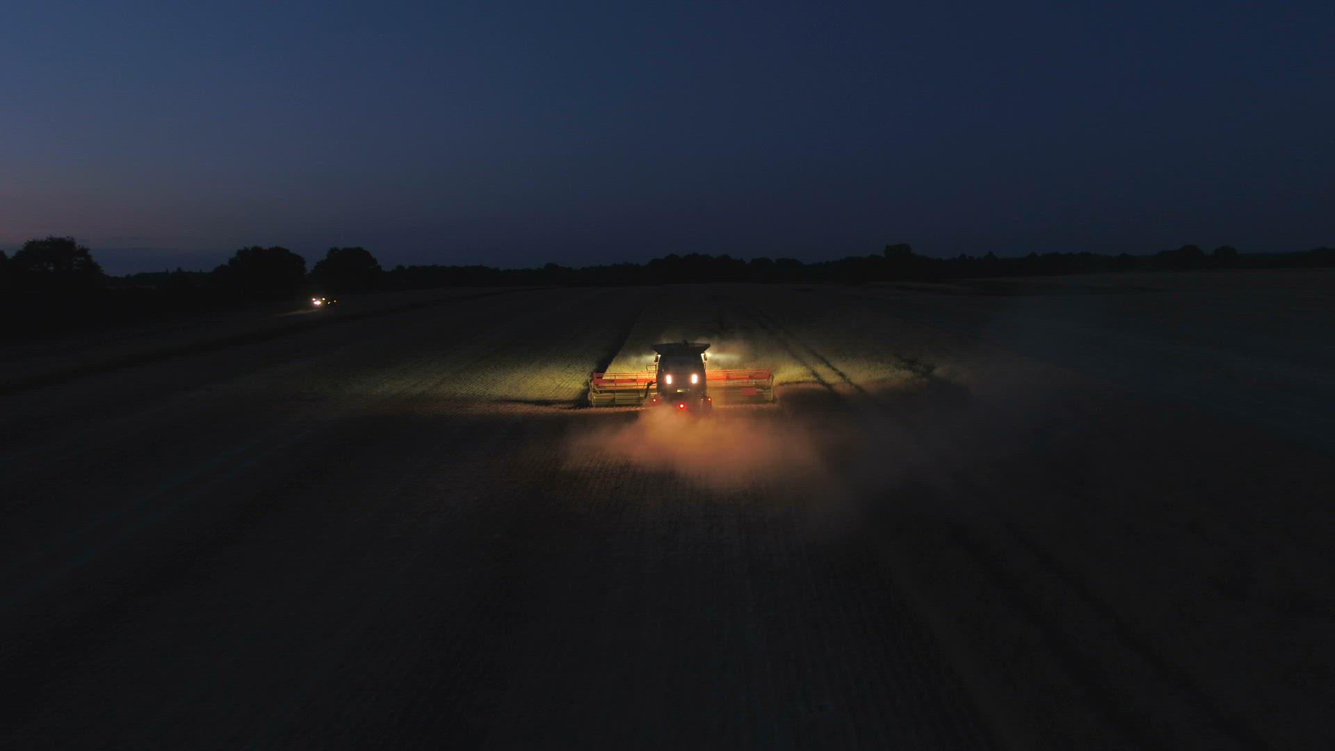 Combine Harvester at Night During the Harvest