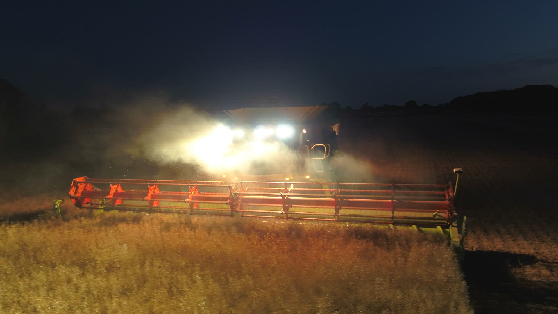 Combine Harvester at Night During the Harvest