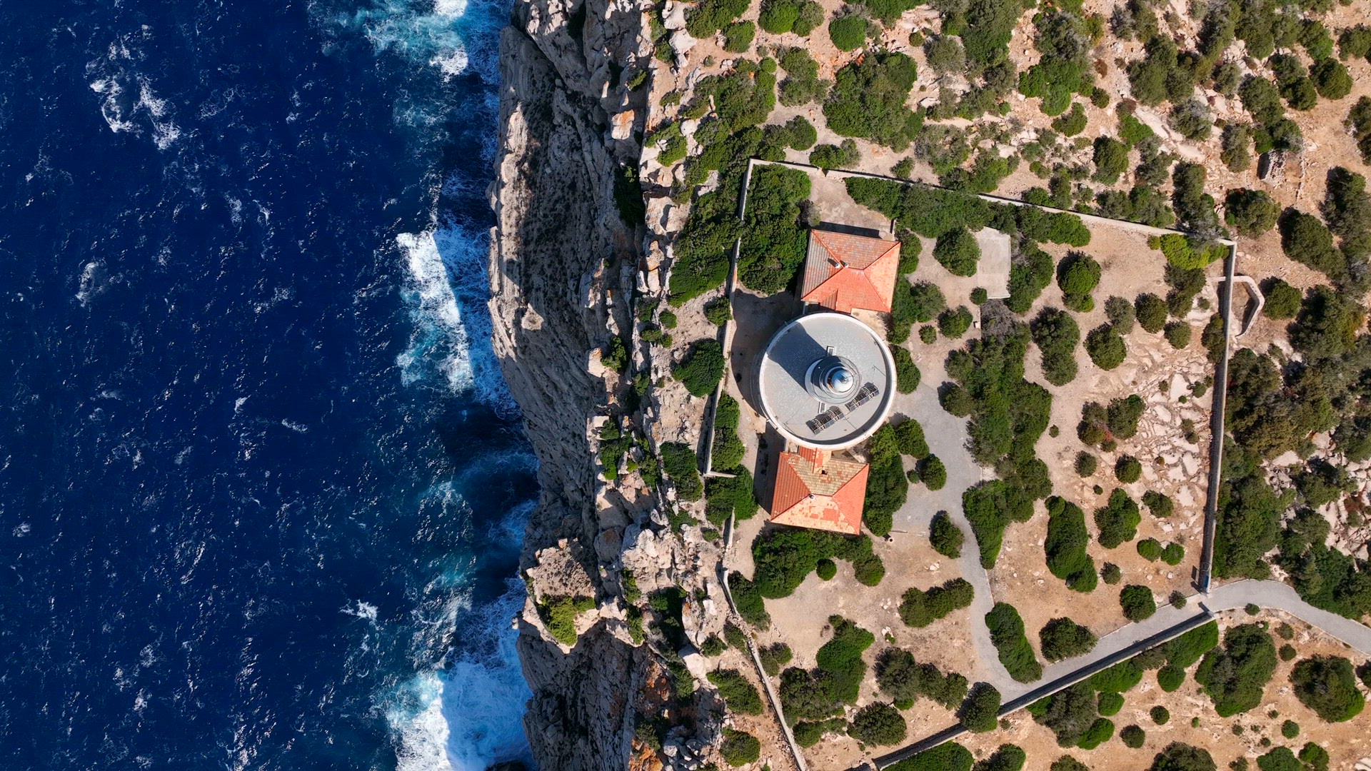 Lighthouse Looking out to Sea on a Cliff in Ibiza