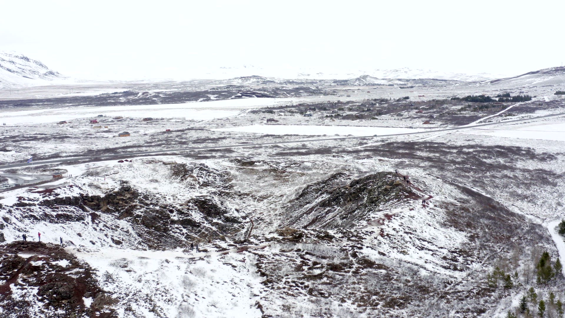 Tourists Looking in to the Snowy Kerid Crater in Iceland Seen From the Air