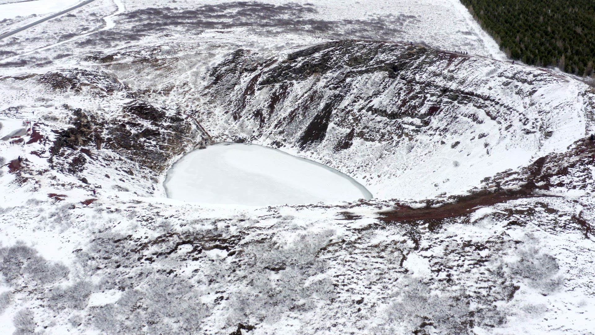 Tourists Looking in to the Snowy Kerid Crater in Iceland Seen From the Air
