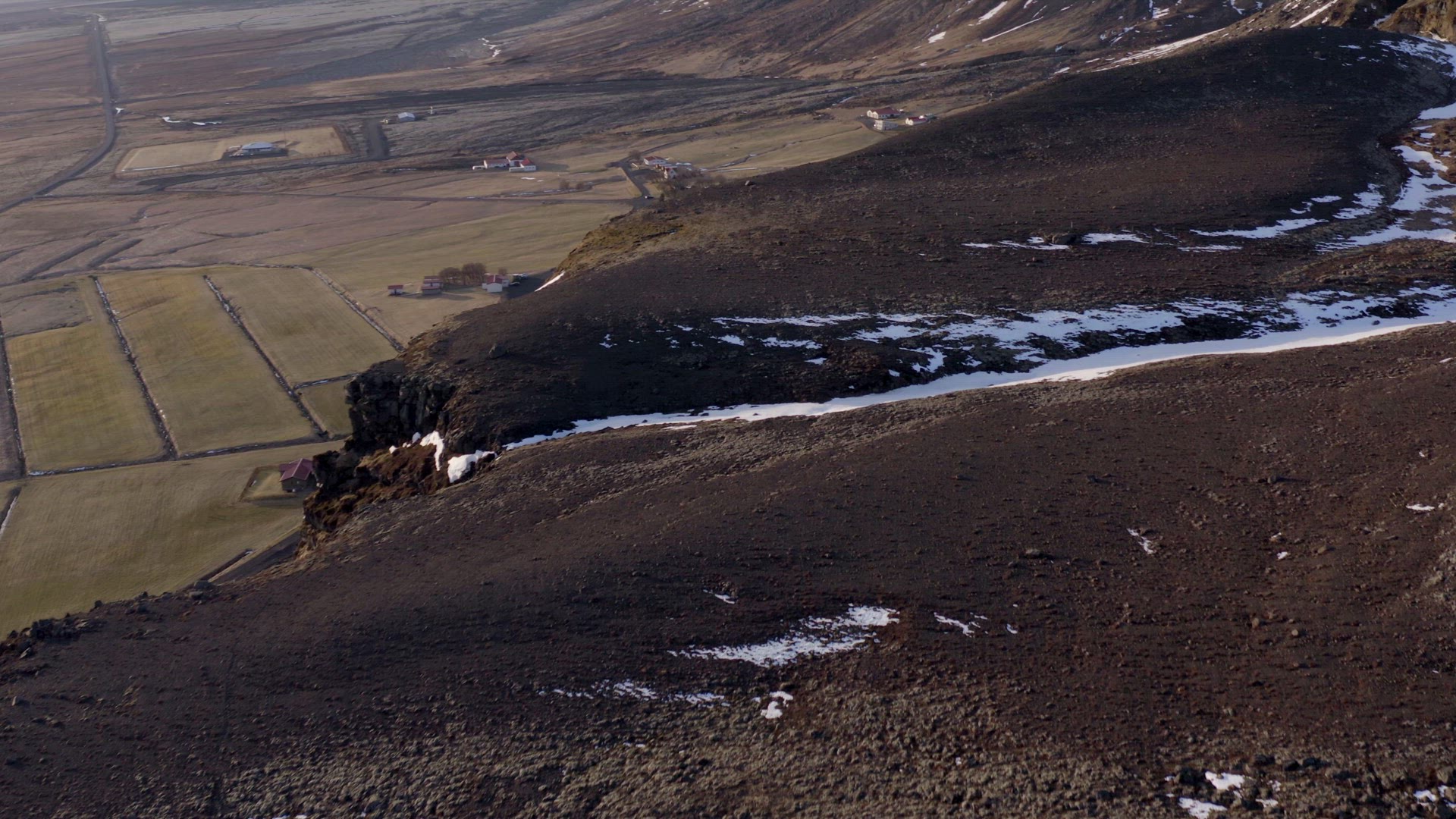 Small Secluded Farm Next to a Snowy Mountain in the Winter