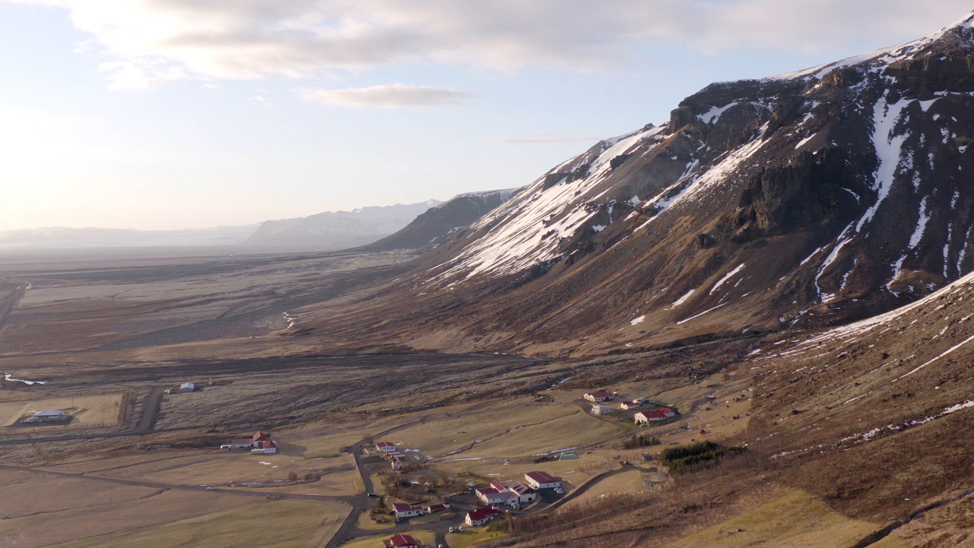 Small Secluded Town Next to a Snowy Mountain in the Winter