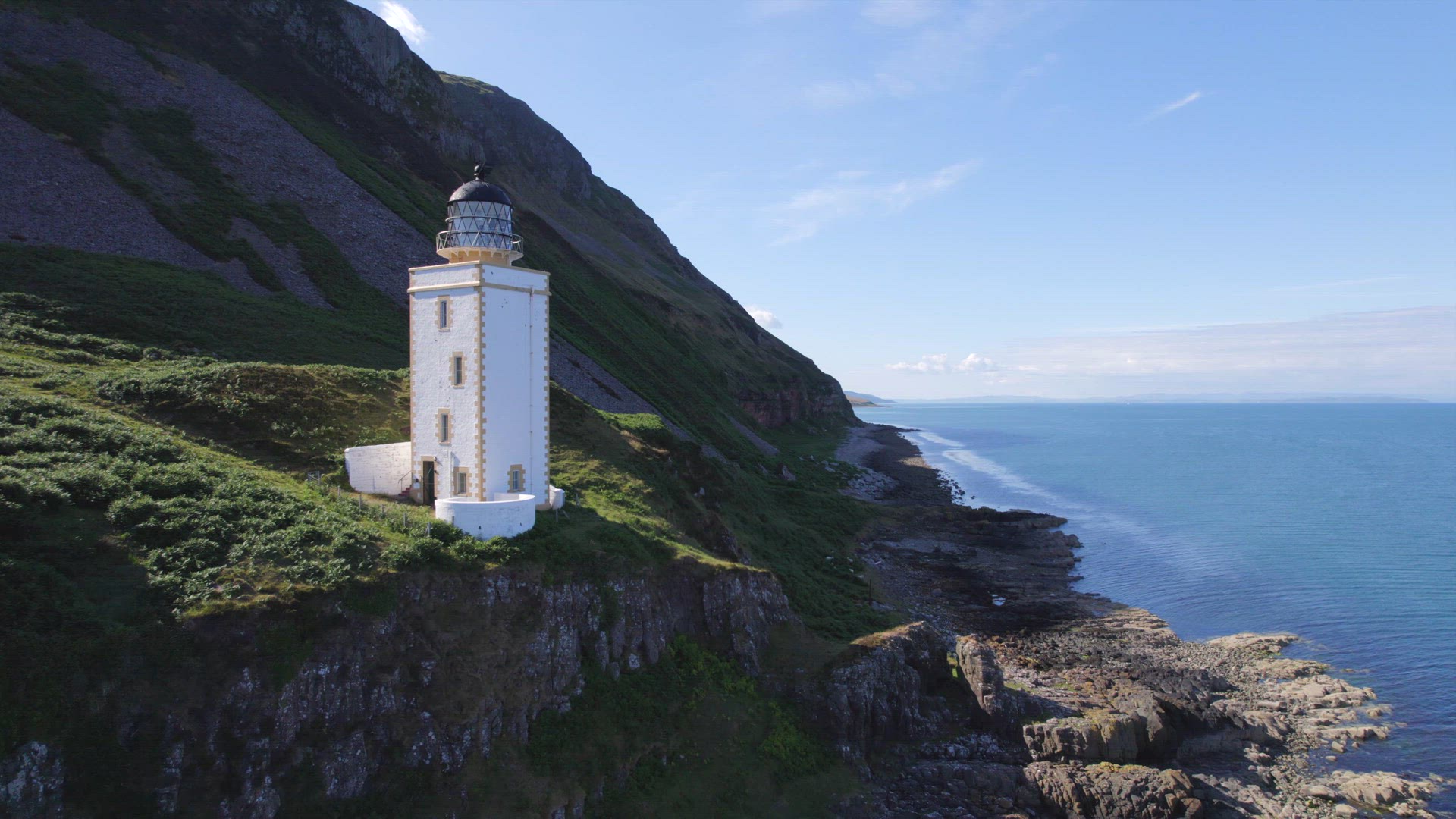 A Beautiful Square Lighthouse on a Cliff in the Summer