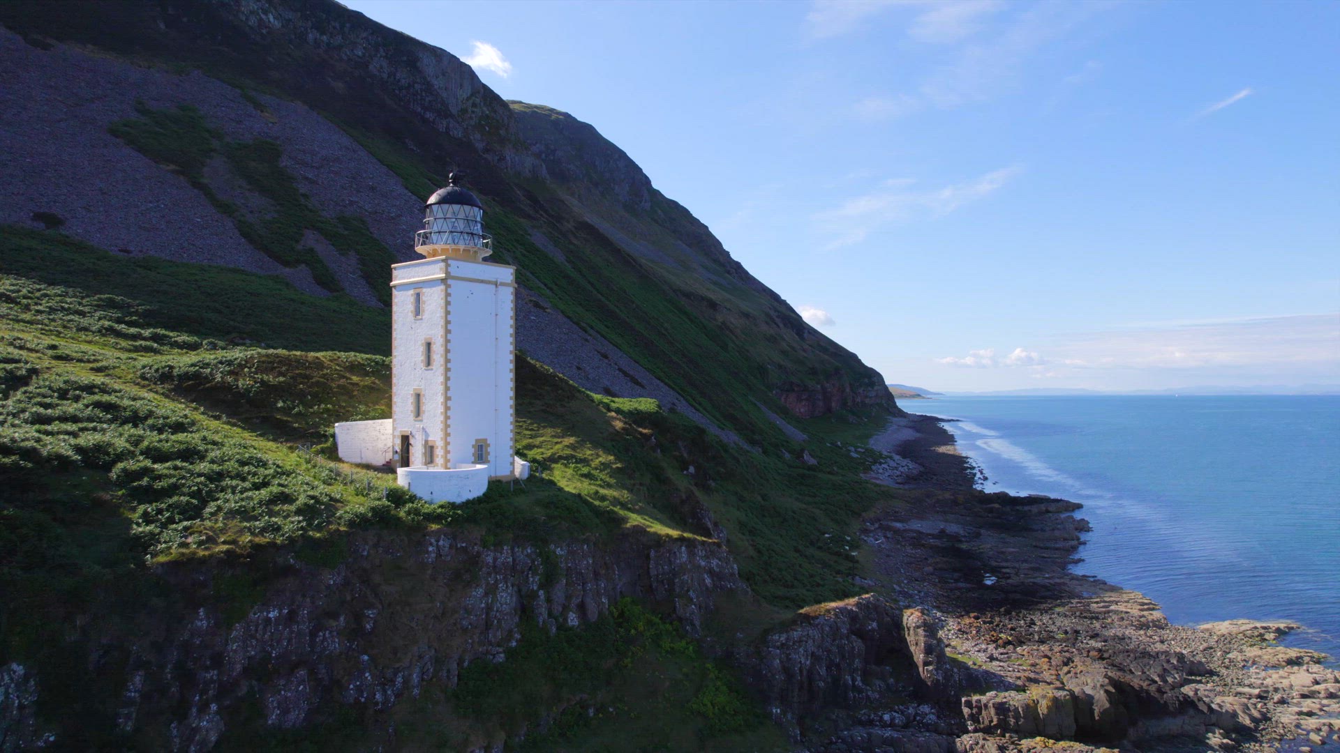A Square Lighthouse on a Cliff Edge Aerial View