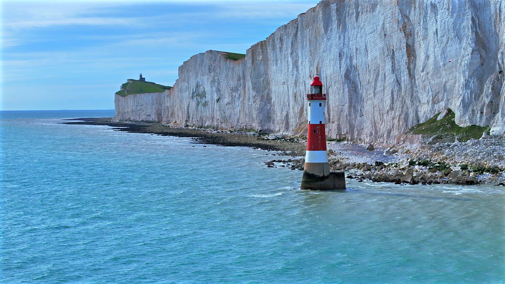 Lighthouse in the Sea with a Large Chalk Cliff
