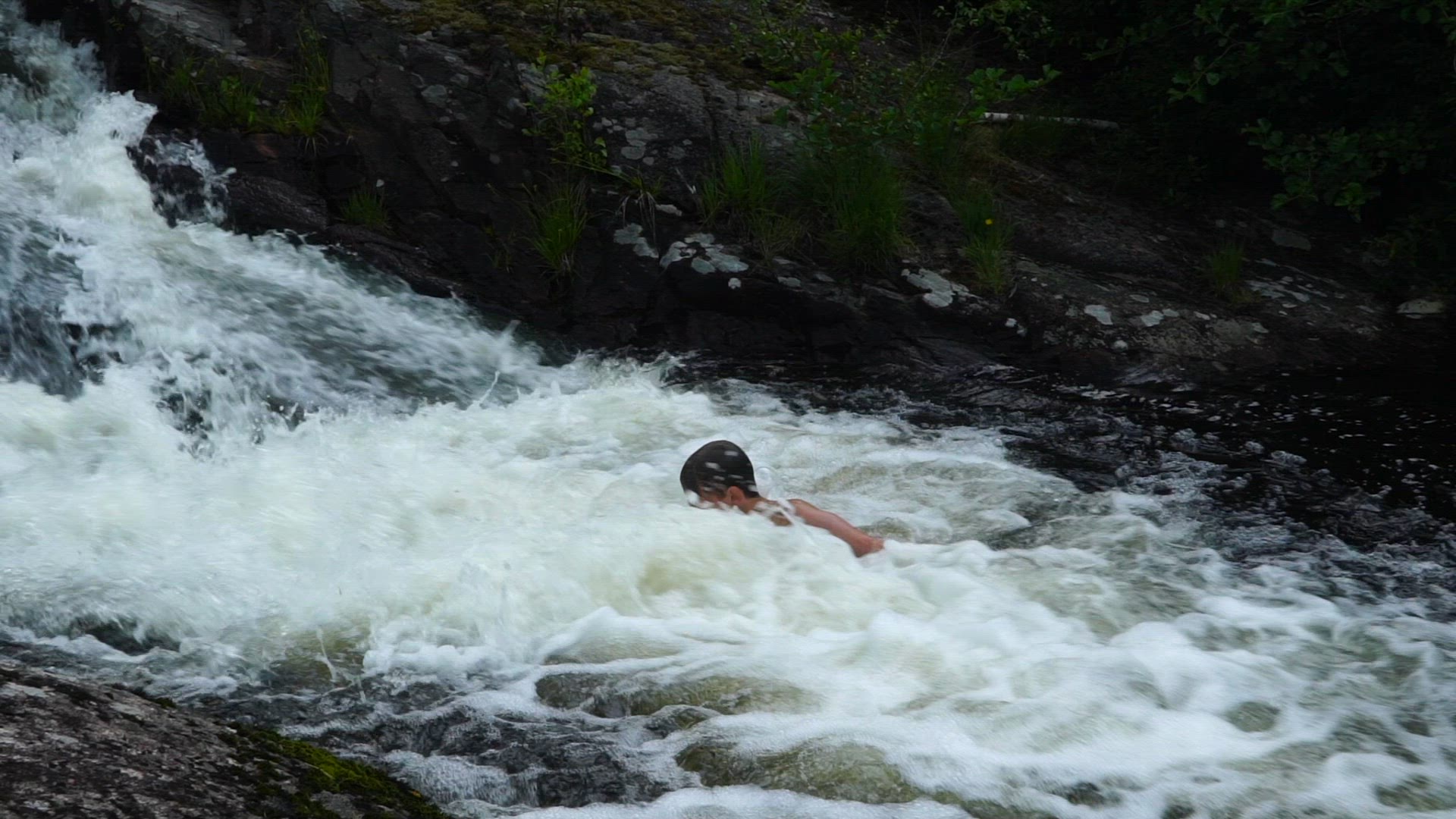 boy playing in waterfall - slow  motion.mp4
