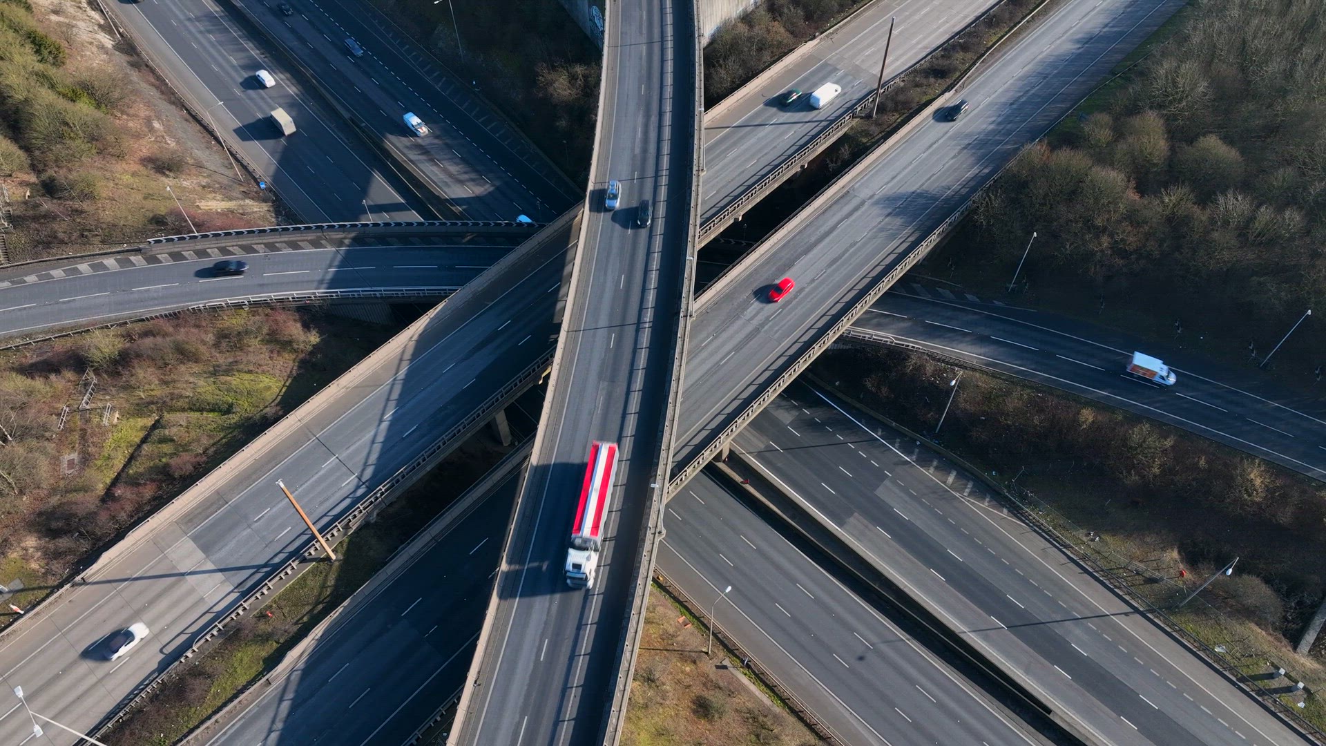 Vehicles Driving Along a Busy Motorway Interchange in the UK Aerial View
