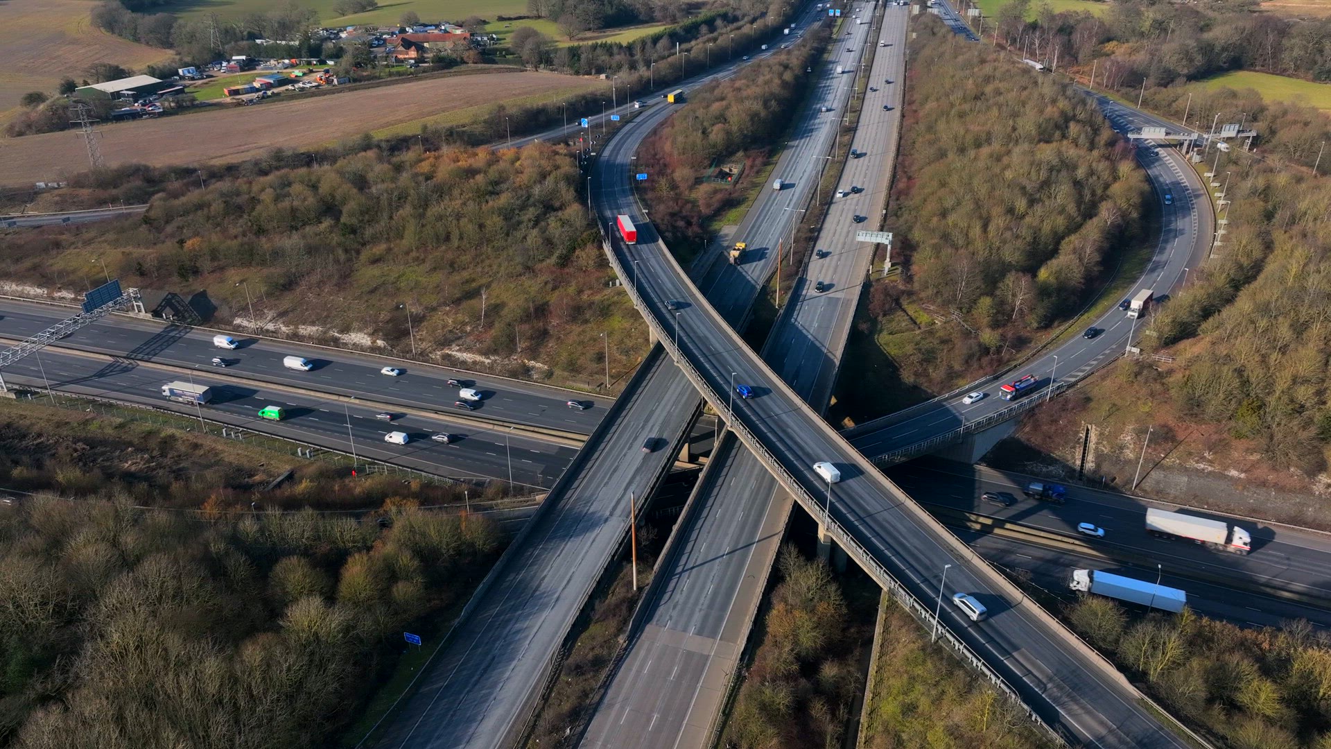 Vehicles Driving Along a Busy Motorway Interchange in the UK Aerial View