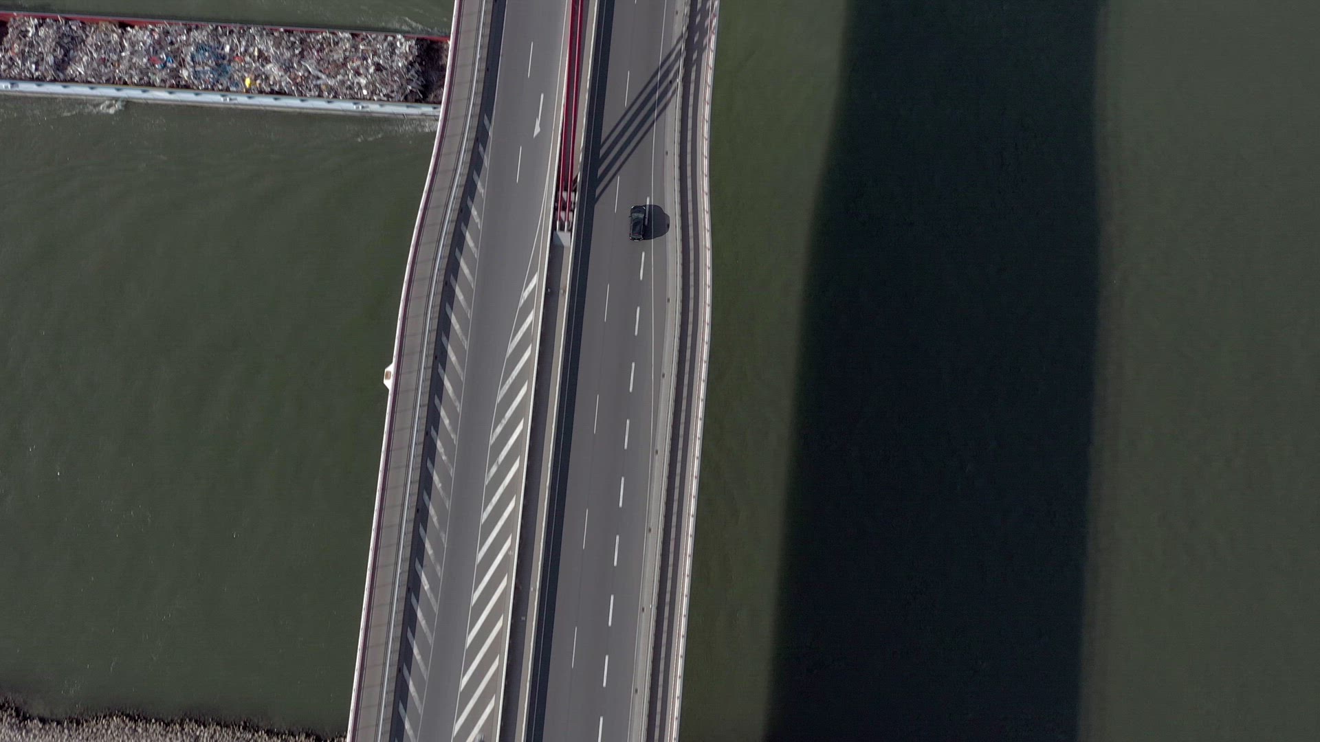 Vehicles Crossing a Cable Stayed Suspension Bridge Crossing a River