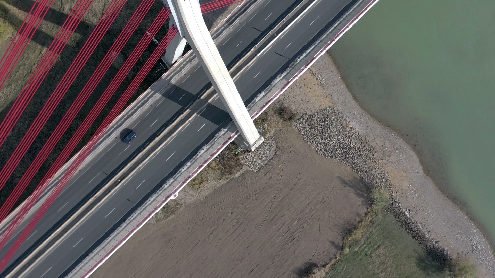 Vehicles Crossing a Cable Stayed Suspension Bridge Crossing a River