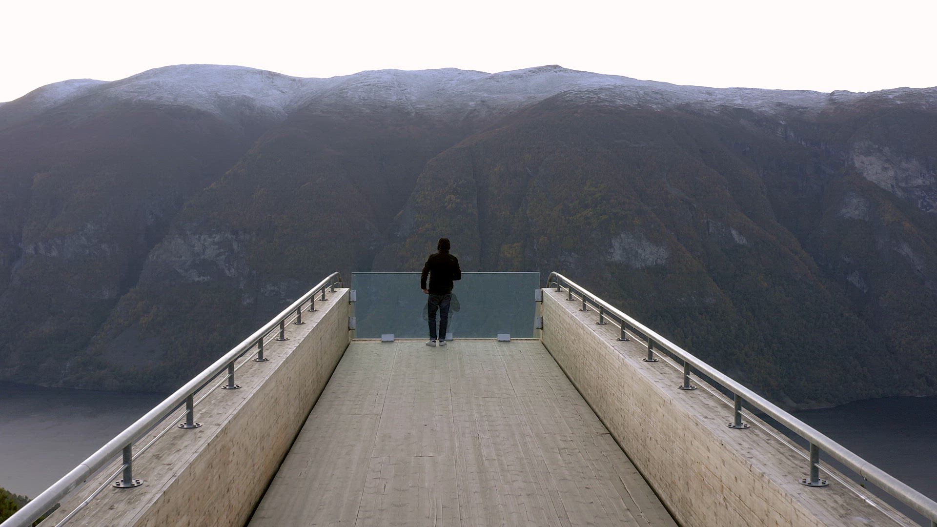 A Tourist Takes in the View from a Lookout Point in Norway