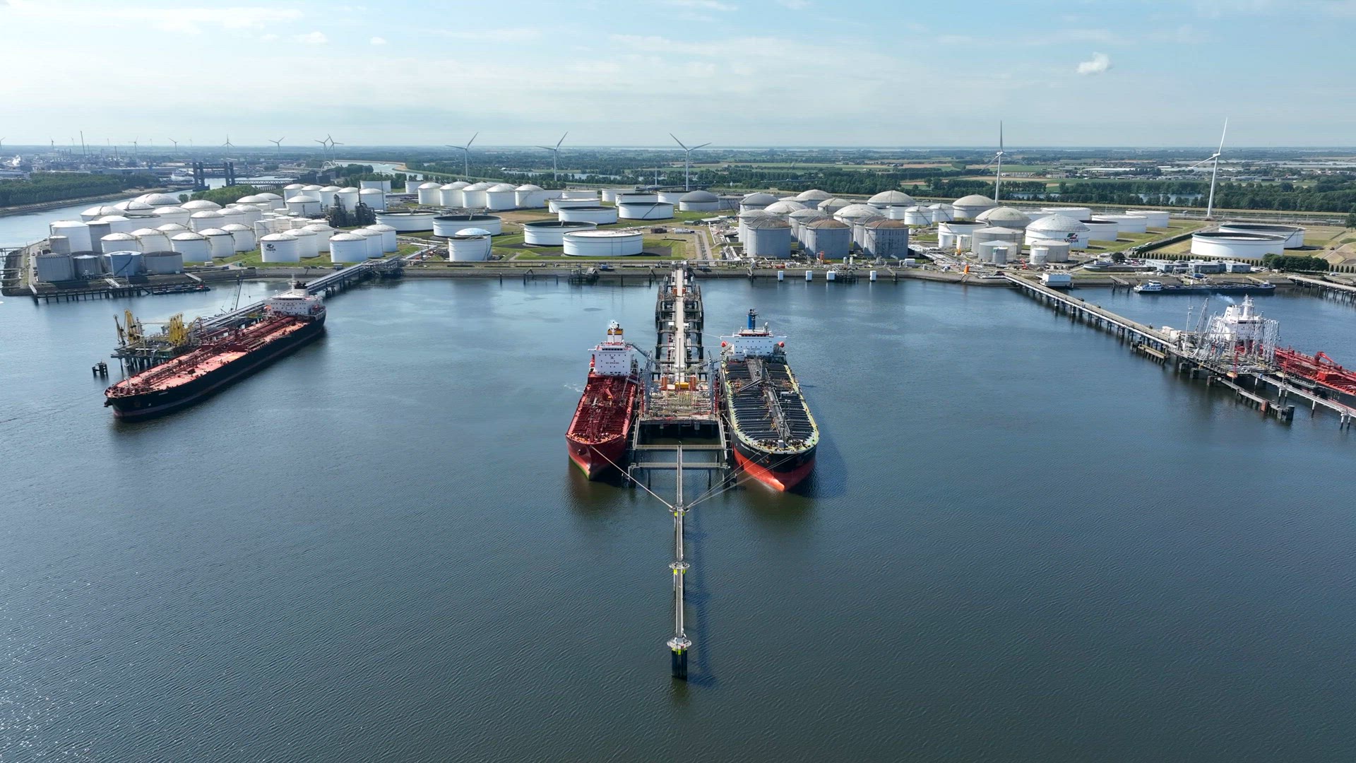 Crude Oil Tanker Ships Unloading Petrochemicals to a Shore Fuel Depot