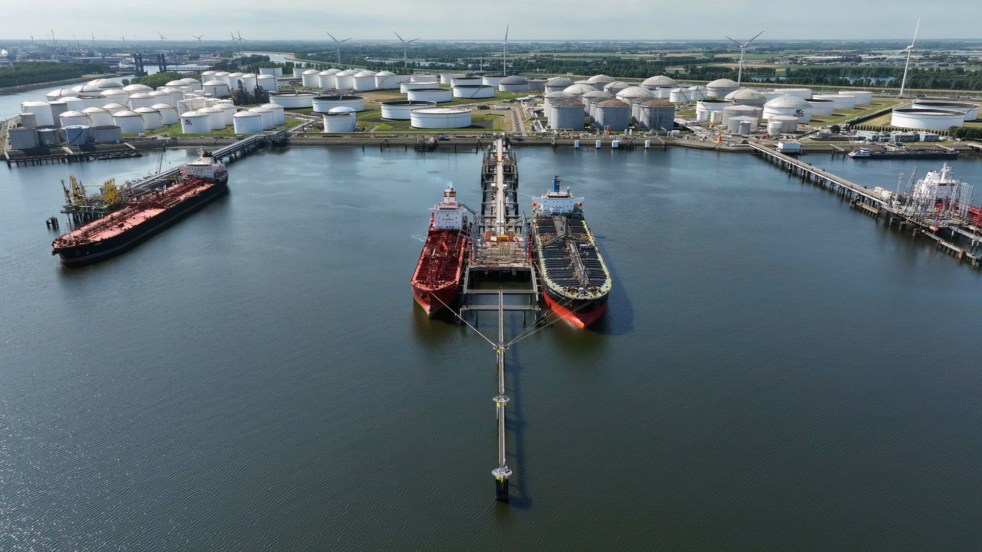 Crude Oil Tanker Ships Unloading Petrochemicals to a Shore Fuel Depot