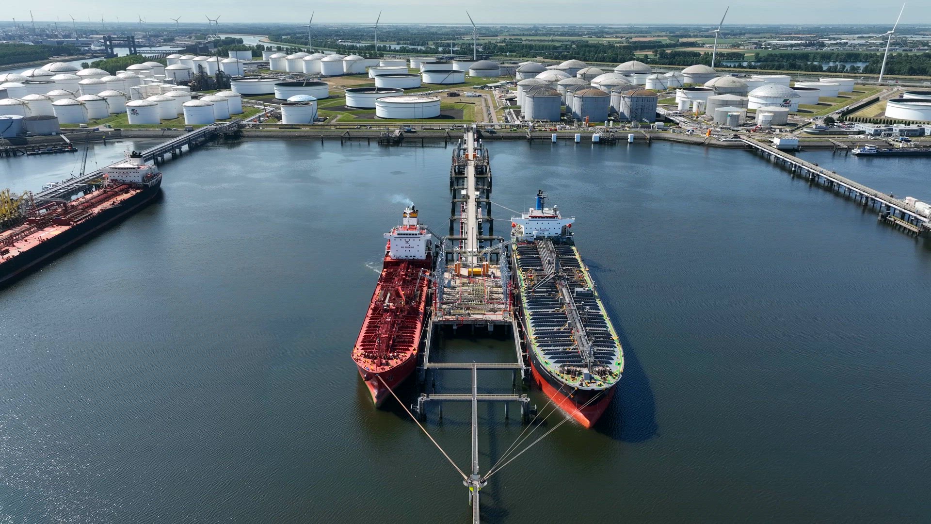 Crude Oil Tanker Ships Unloading Petrochemicals to a Shore Fuel Depot