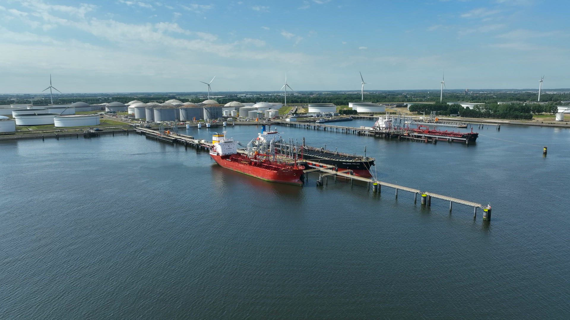Liquid Cargo Transporter Ships Unloading Crude Oil to a Fuel Depot