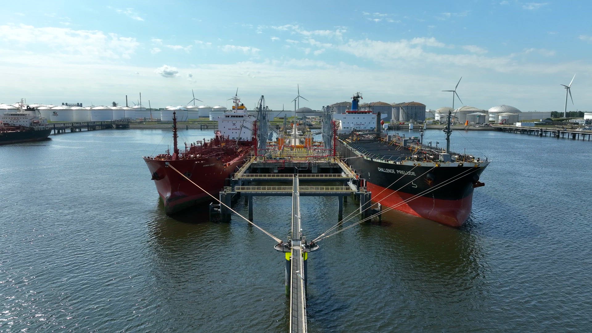 Crude Oil Tanker Ships Unloading Petrochemicals to a Shore Fuel Depot