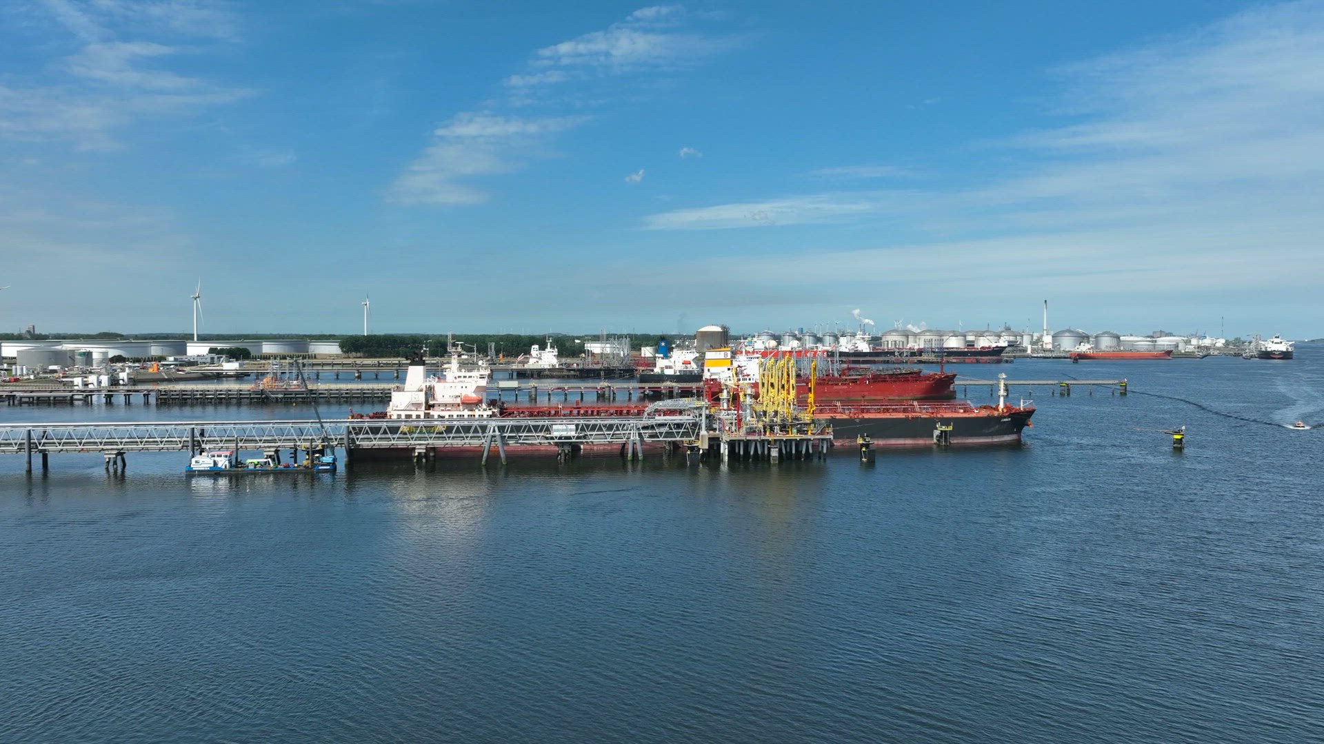 Crude Oil Tanker Ships Unloading Petrochemicals to a Shore Fuel Depot