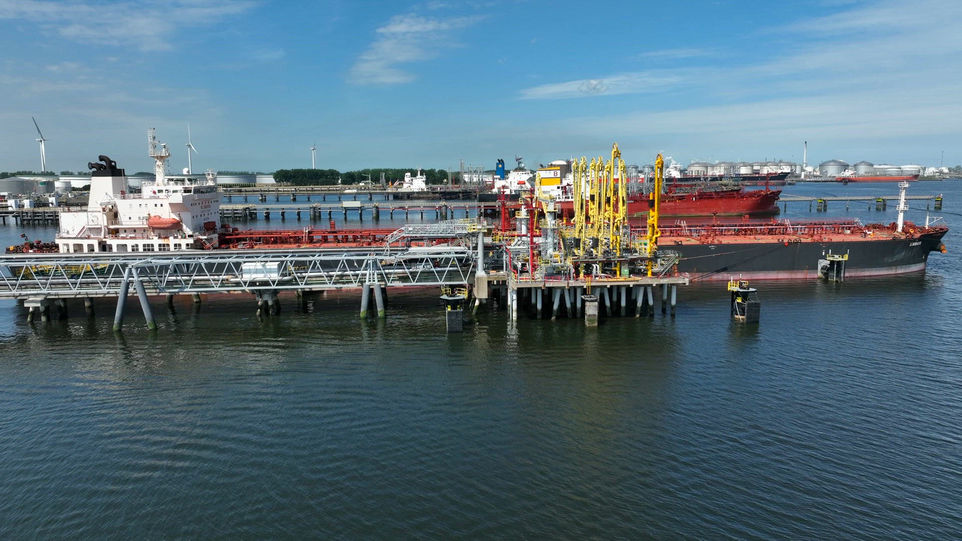 Crude Oil Tanker Ships Unloading Petrochemicals to a Shore Fuel Depot
